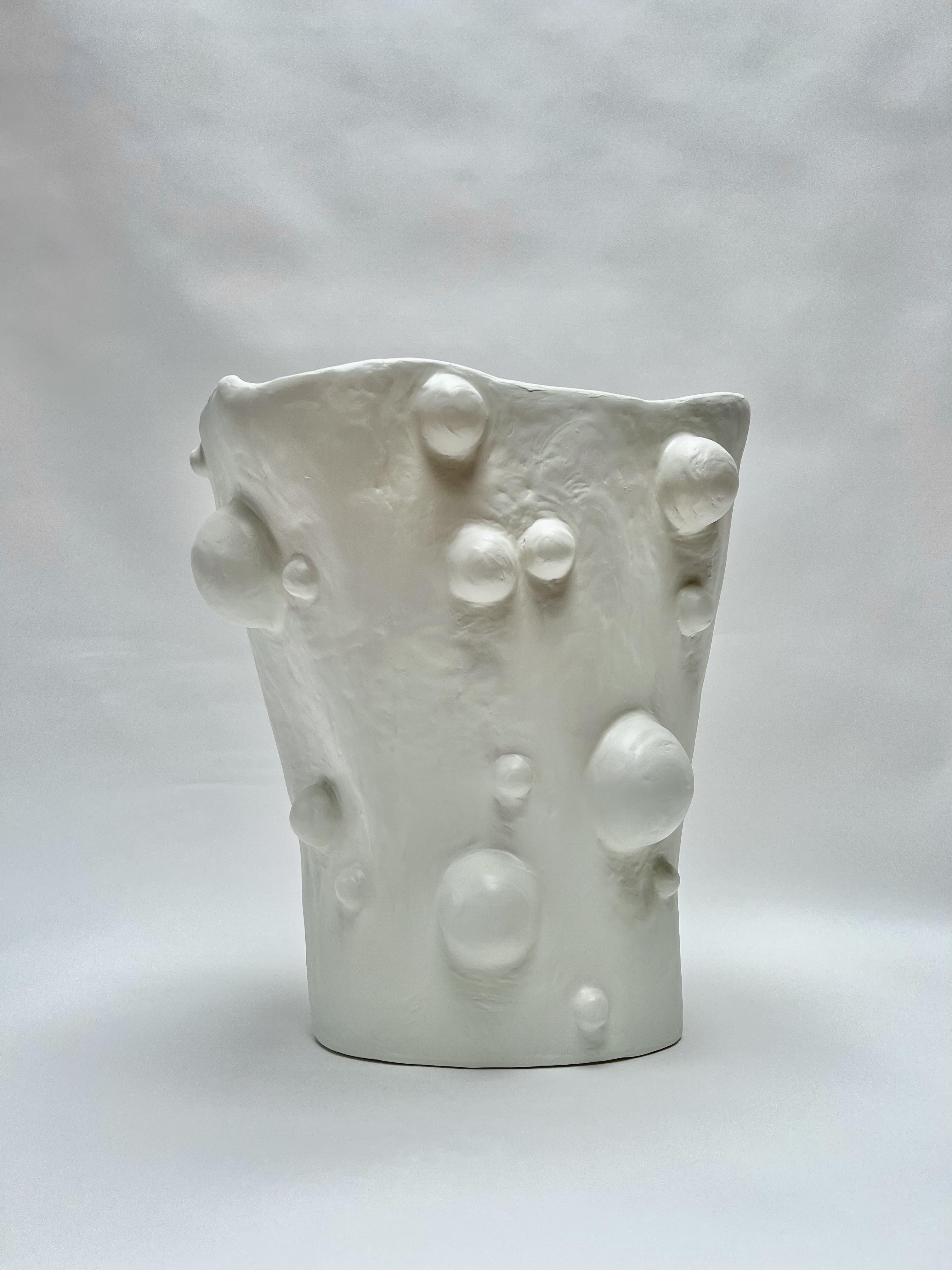 The Large Breakout Vase by Brent Warr is a sculptural statement piece that embraces organic form and material experimentation. Hand-shaped from a proprietary blend of gypsum, pulp, and epoxy, the vase features a fluid, asymmetrical silhouette