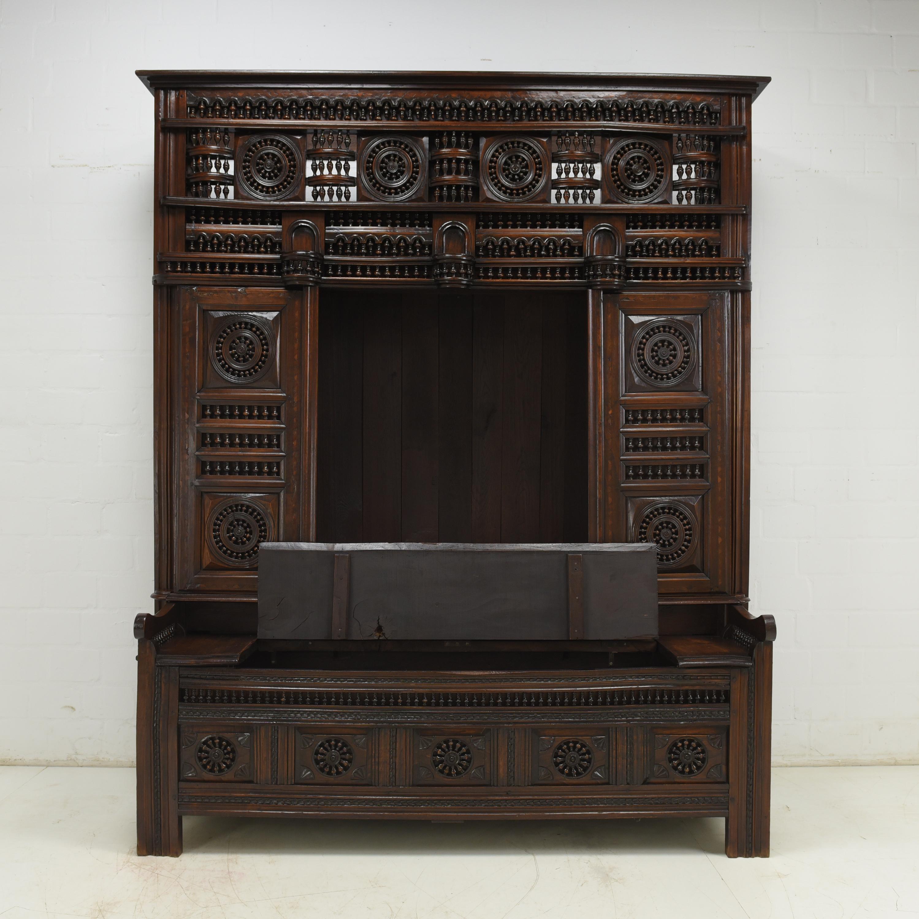 Large Breton cupboard with bench restored around 1900 chestnut

Features:
Four sliding door elements that can be moved separately
Foldable bench with storage space
Very complex processing
Decorated with hundreds of small turned