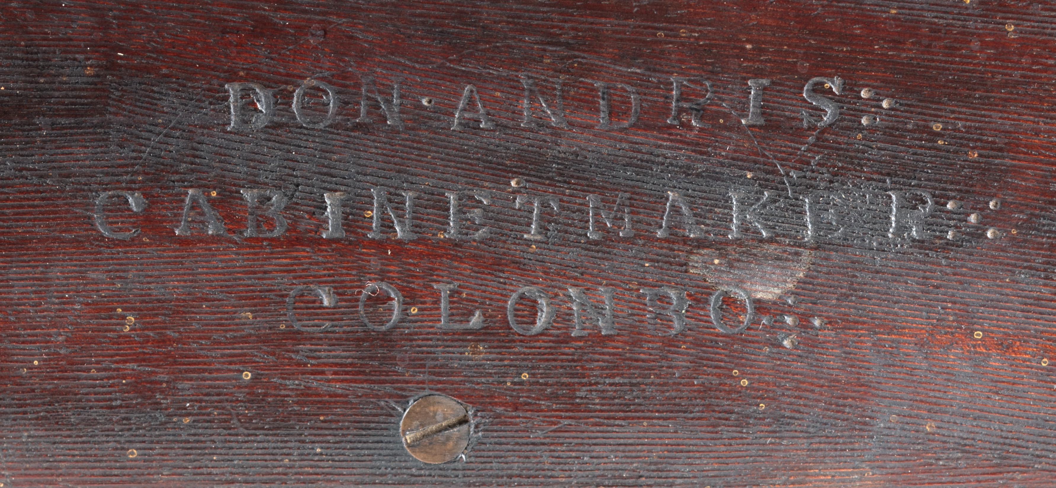 A Sri Lankan ebony wall bracket by Don Andris Cabinet Makers, Colombo

Colombo, first half 19th century, stamped Don Andris, Cabinet Makers Colombo on shelf

The shelf suspended by three foliate motif carved rests and one plain rests to the