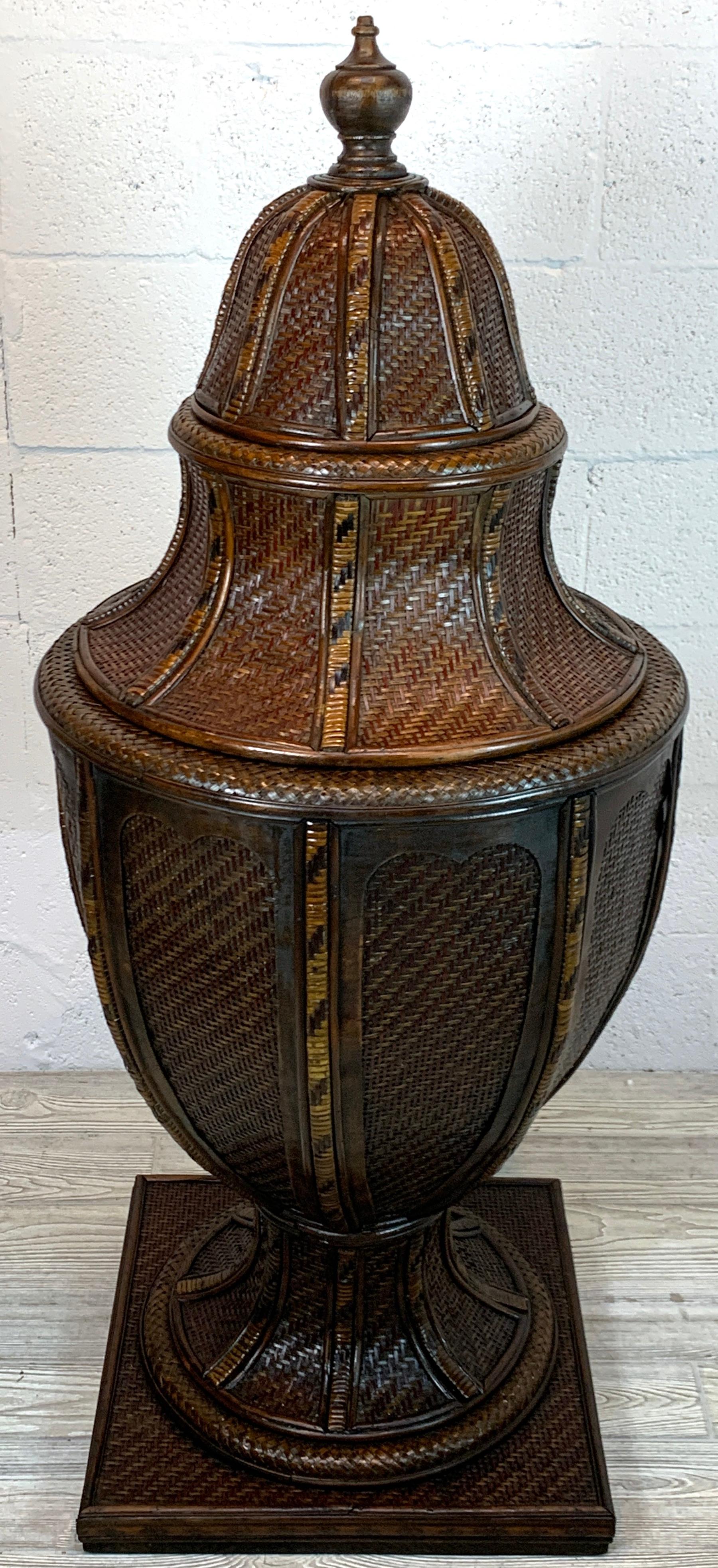 Large British Colonial style rattan and wicker urn, with carved wood finial, the domed top with intricate woven rattan, reed, willow and wicker, with a conforming body. 
The urn stands 51