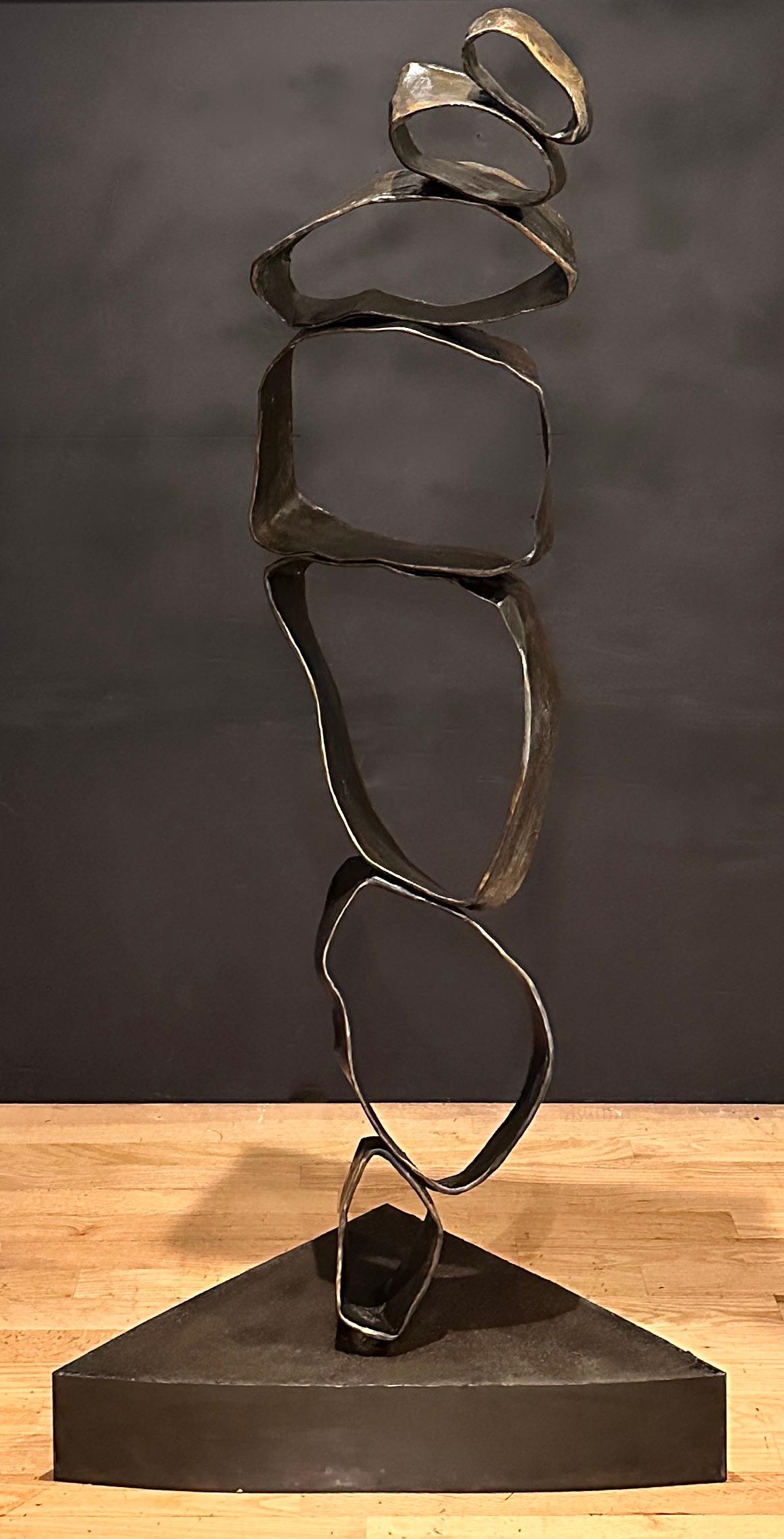 Unusual and large abstract amorphous bronze sculpture. This life size floor sculpture consists of seven(7) circular and oval bronze pieces mounted together in a modern totem of abstract modern form. Unmarked.

