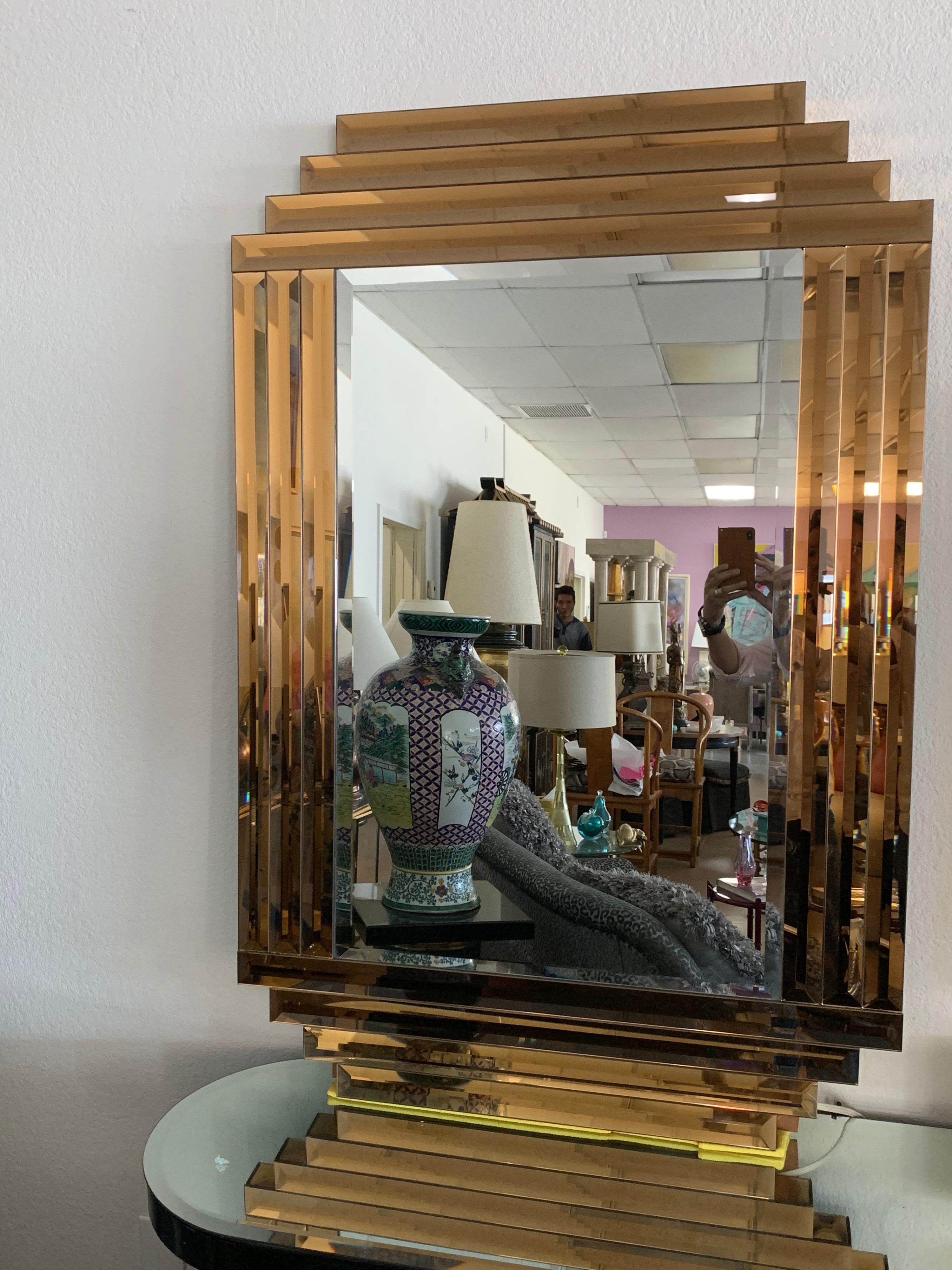 This is one of the most substantial and glamorous mirrors we’ve ever had in the shop. From a multi million dollar desert a state this mirror screams dynasty but is still as modern today as it was 40 years ago. Amazing bronze color beveled glass