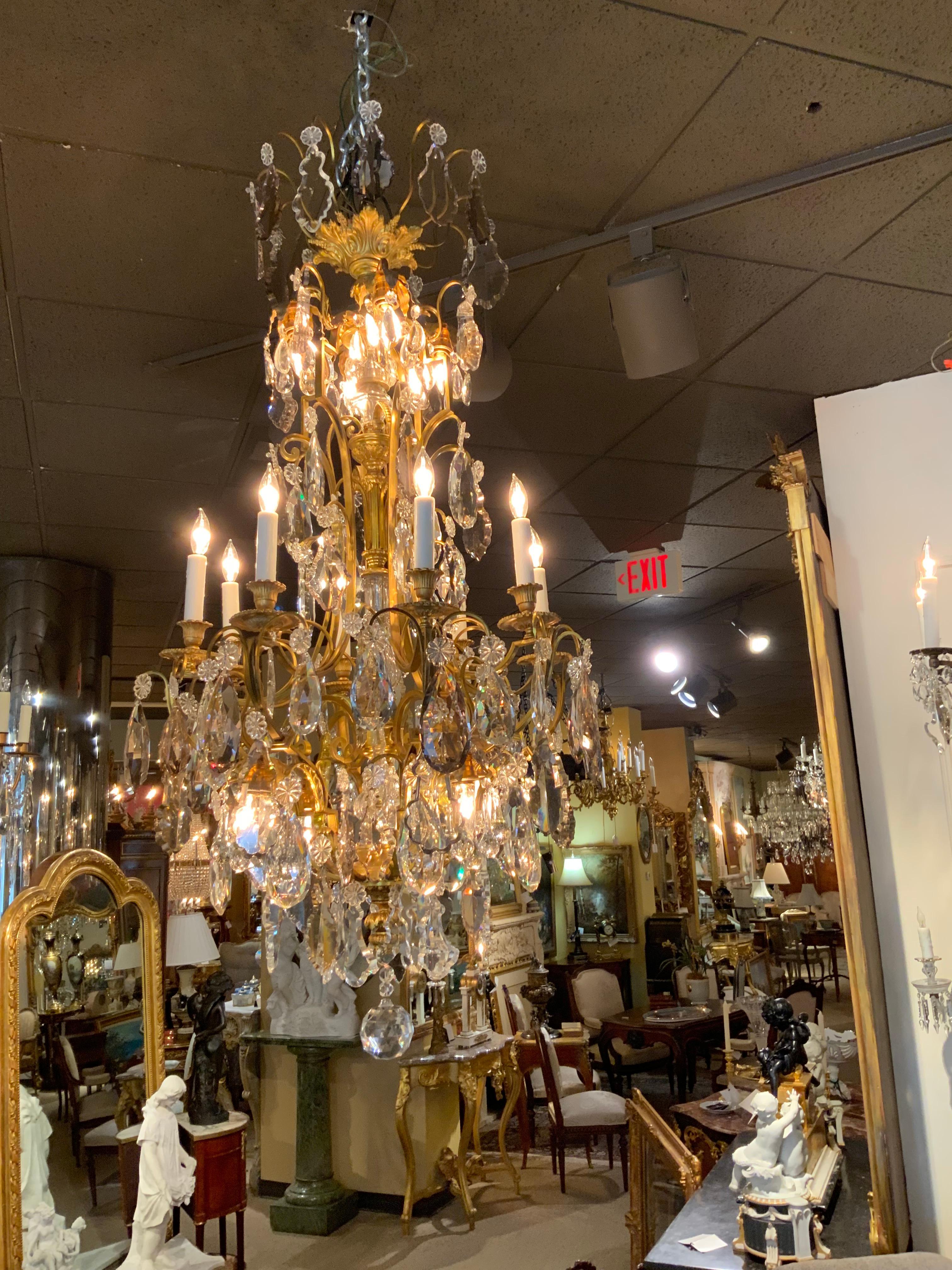 This chandelier is very tall and elegant. The bronze work
Is finely cast and there are eight lights around the perimeter 
With eight lights that are down lights. The prisms are clear 
And lavender in hue. Wiring is excellent and the crystal
Is