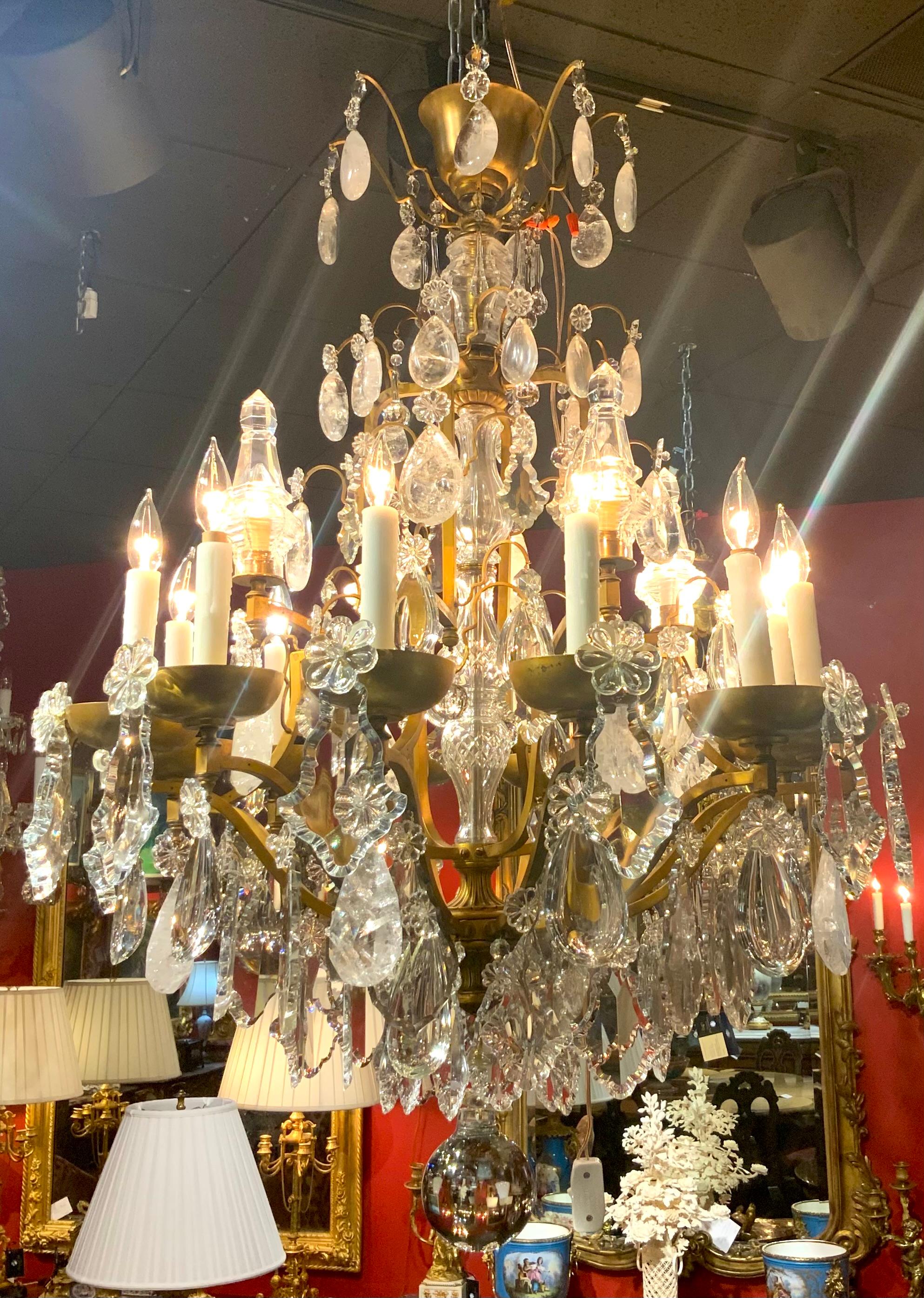 Large and exceptional rock crystal and clear crystal chandelier
That has large spires with lights within. The wiring is good
And the crystal is in perfect condition. It has twelve lights
Around the perimeter with gilt bronze bobeches. 