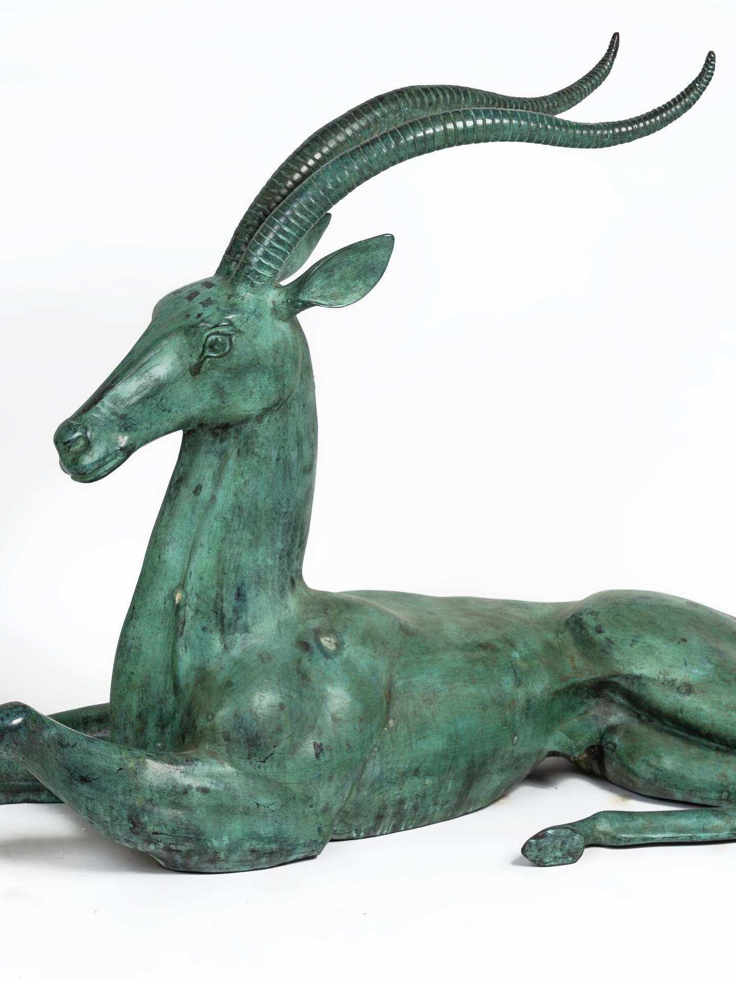 Fabulous addition to any decor, large bronze handcrafted North African resting antelope sculpture. Very large vintage midcentury solid hollow cast bronze antelope sculpture in great condition and fine details. Handmade decorative metalwork bronze