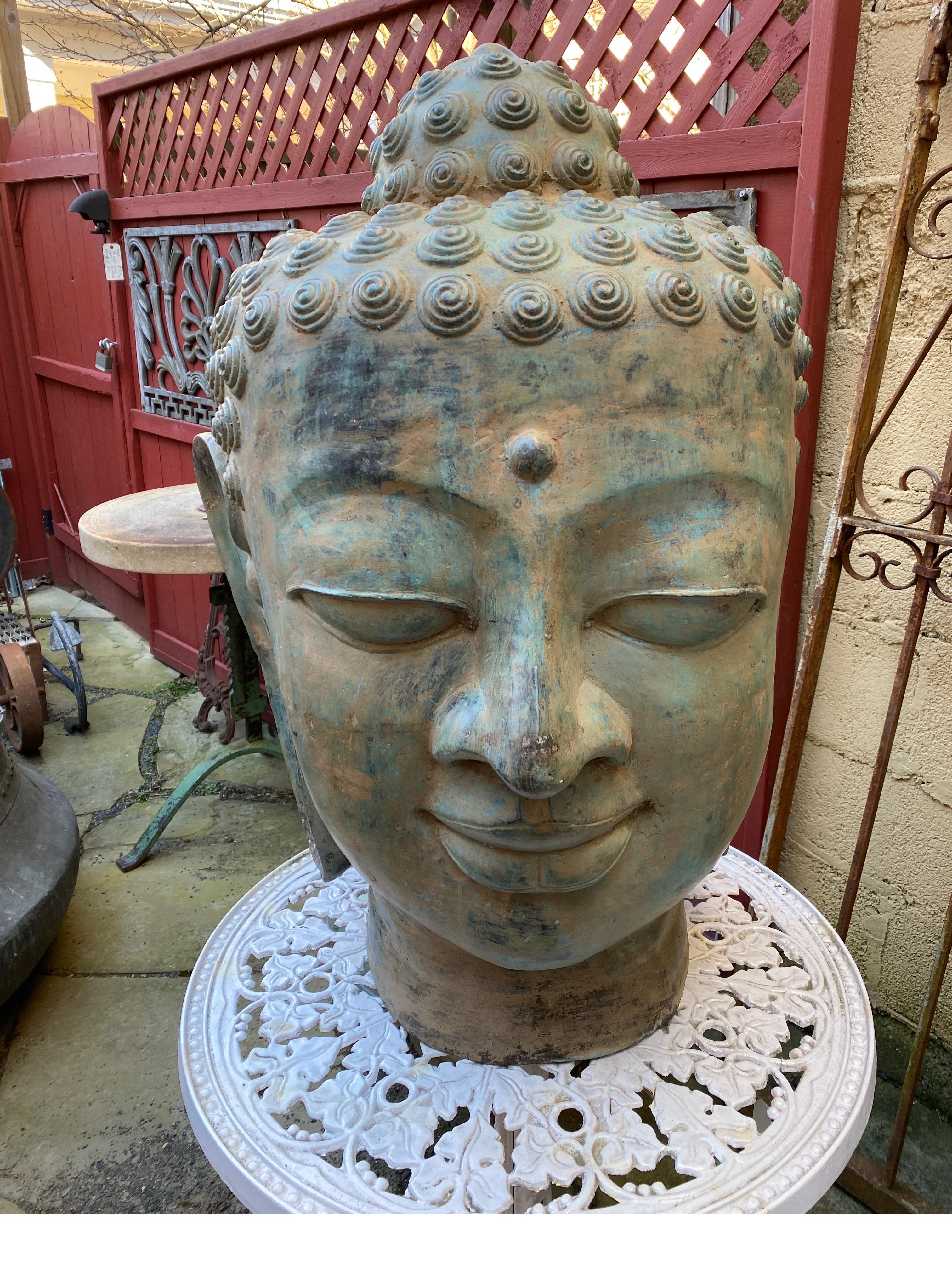 Fabulous large bronze Buddha head with original aged verdigris surface. Impressive statement piece, 35 inches tall, mid 20th Century China.
