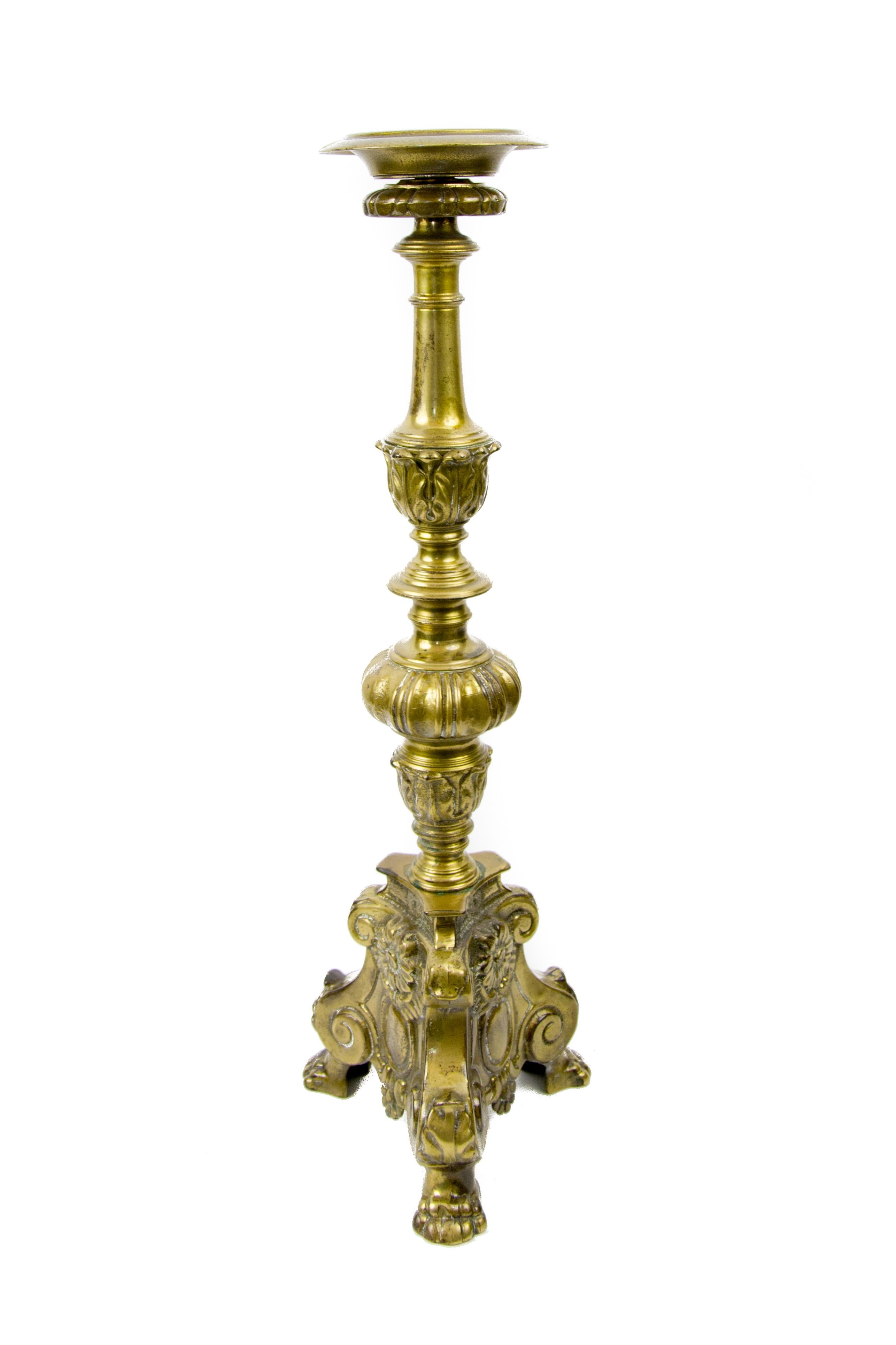 Large French Baroque candlestick on shaped triangular base with lion paw feet.
Measures: Height is 60 cm / 23.62; the base is 20 cm / 7.87 in wide; diameter of the top is 13 cm / 5.11 in.