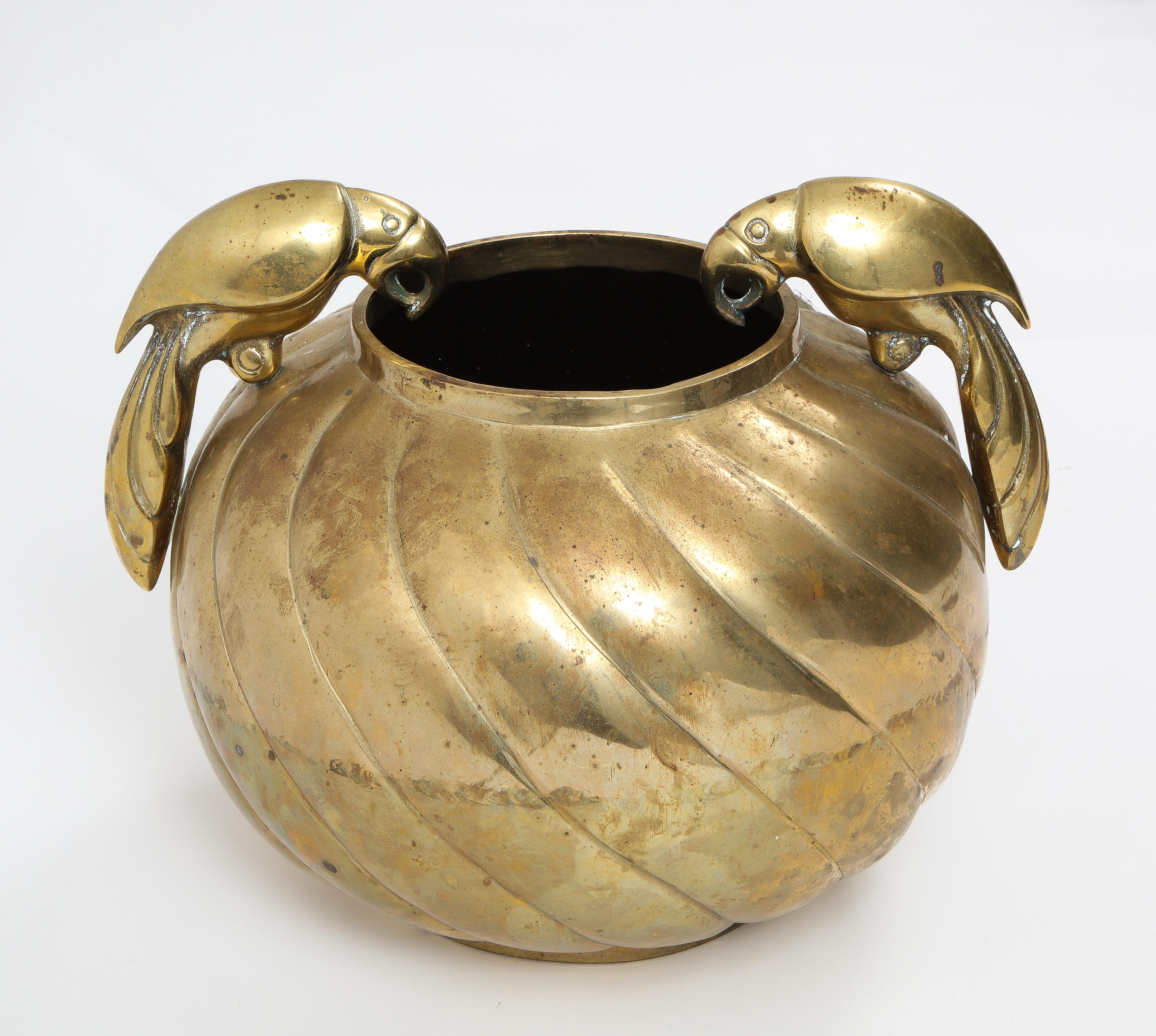 A stunning centerpiece in cast bronze with a grooved motif adorned with solid bronze cast parrots.
