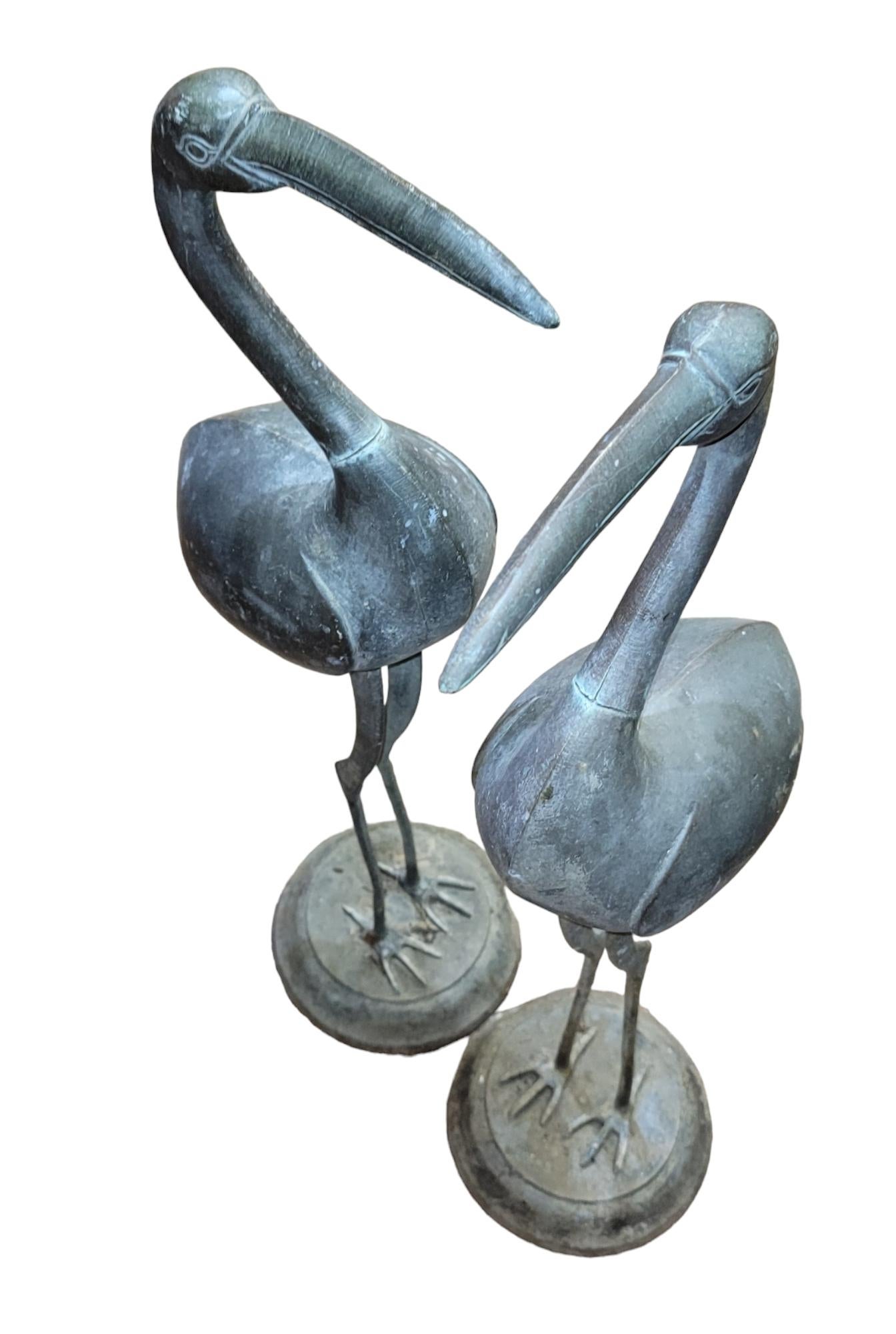 Large life sized pair of crane garden statues standing straight up in the stance of attention. The base is circulars and holds the cranes in place and balanced. measures approx - 30h x 5w  x 10d
