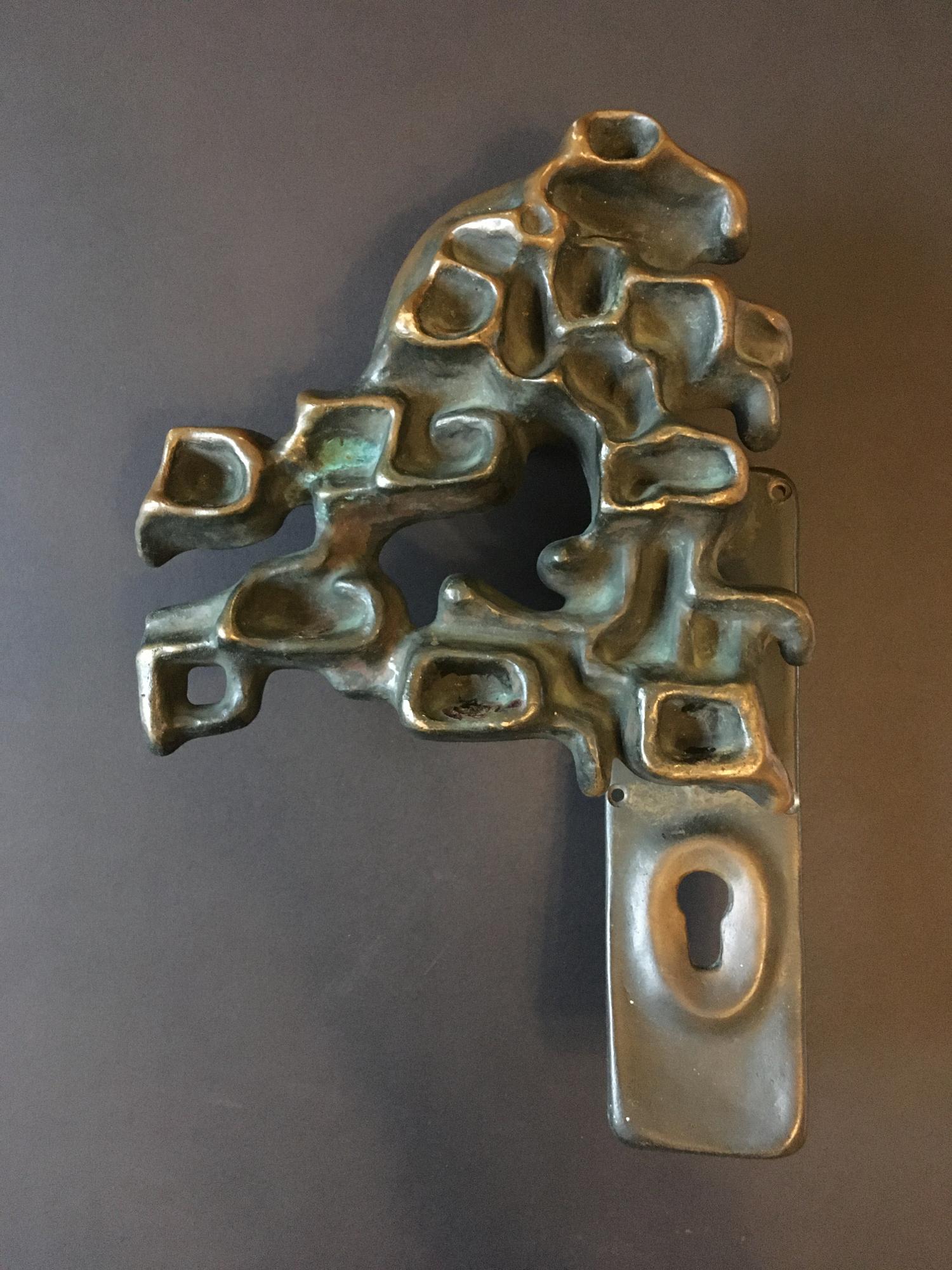 Large bronze door handle in organic form, nicely sculpted and cast, on a rectangular plate with securing bolt to reverse. Found in Germany, dated 1980.

Good vintage condition with minor wear from age and use, and a heavy patina, including some old