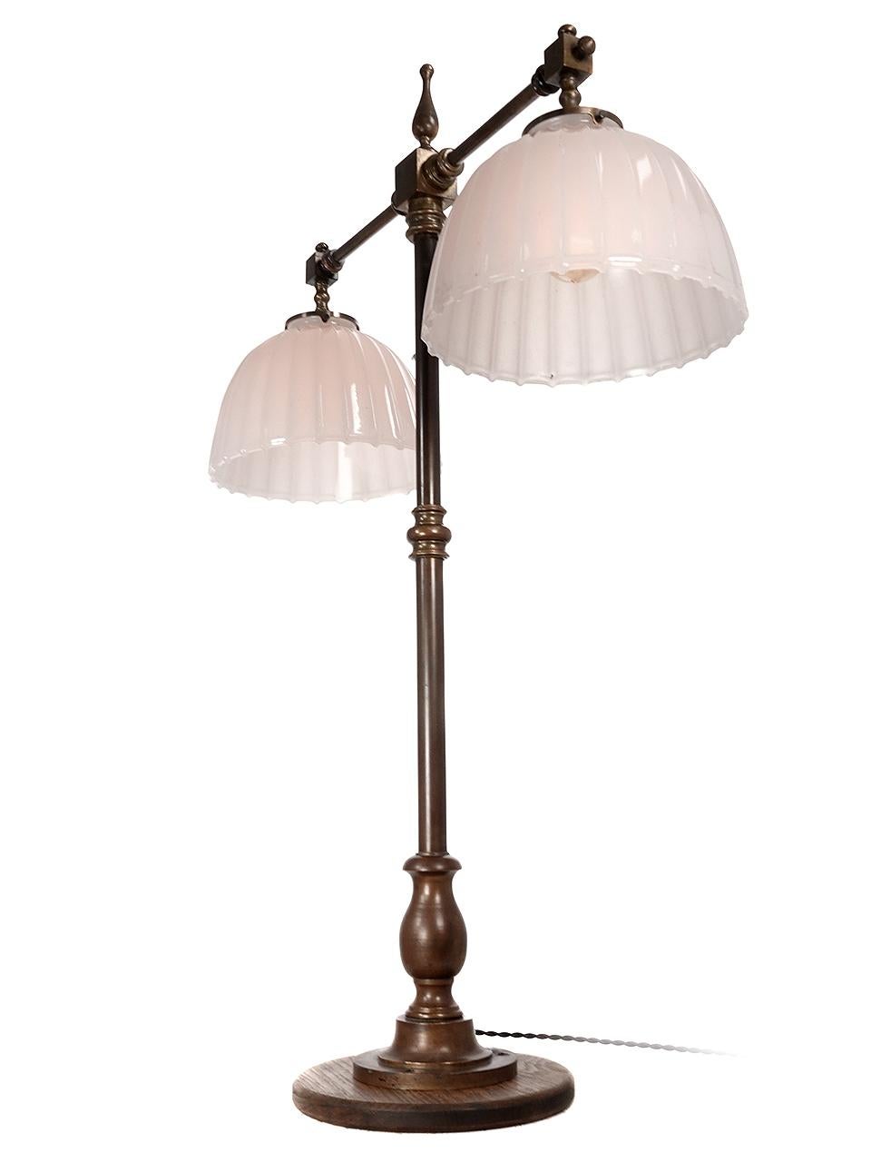 This is a very impressive desk/counter top bank lamp. Its stands 41 inches tall. The metal is all bronze in the original finish. There are 2 heavy clam broth fluted domes that each have an 11 inch diameter. This type of fixture was designed to bolt