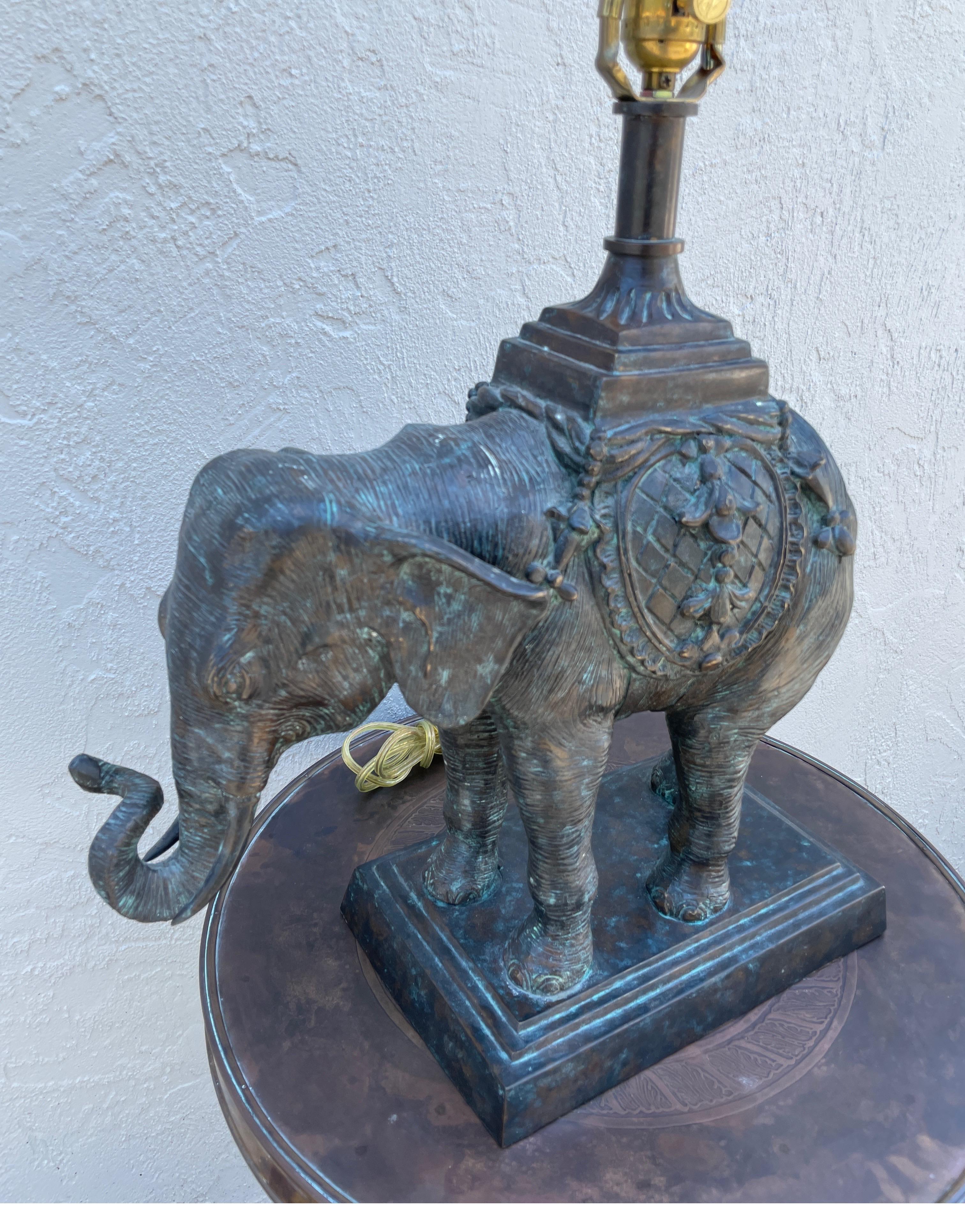 Large bronze elephant lamp with trunk up for good fortune.