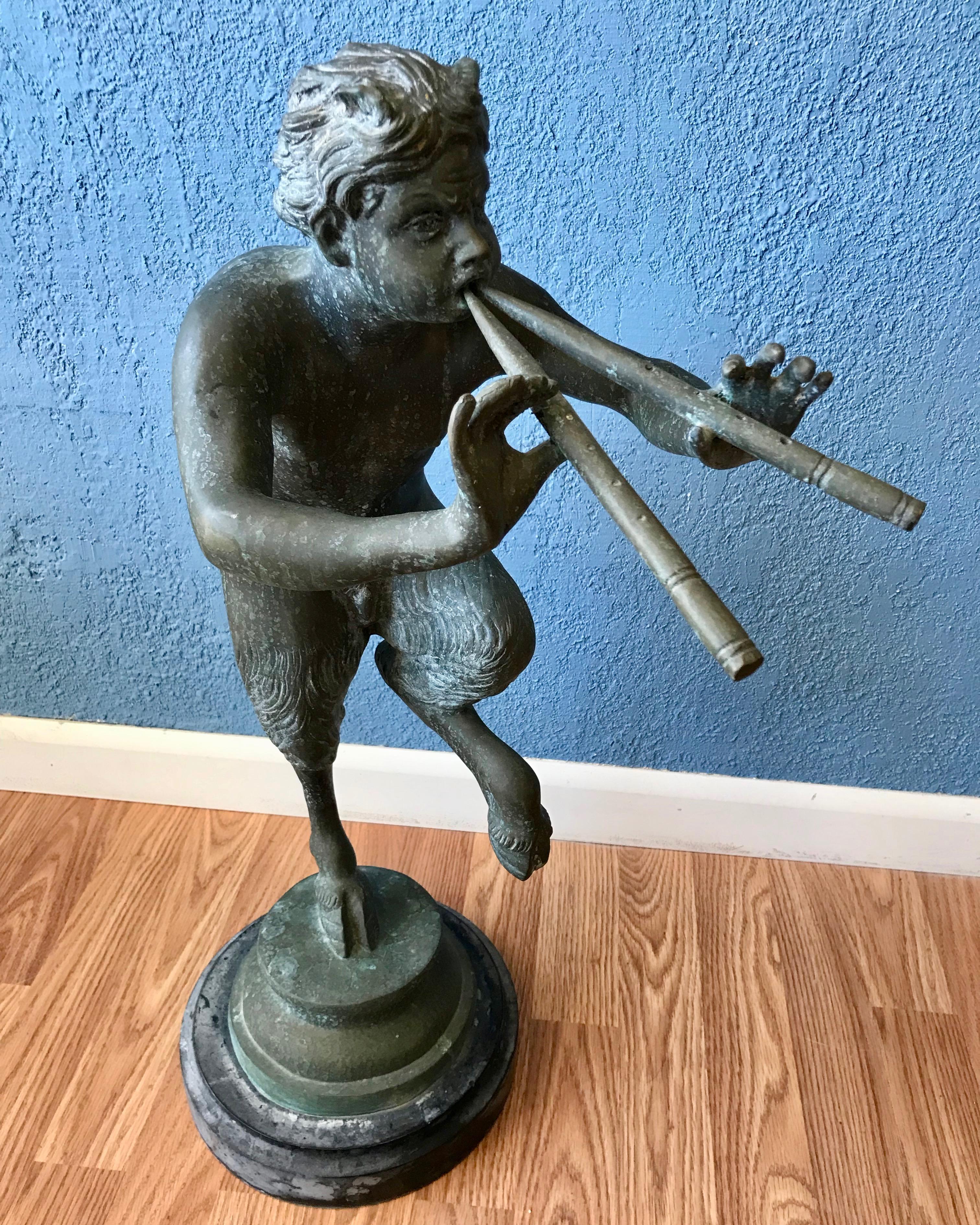 Impressive in scale with fine casting.
A verde gris patina from outside exposure. 
A classic pose with the figure playing the pipes.