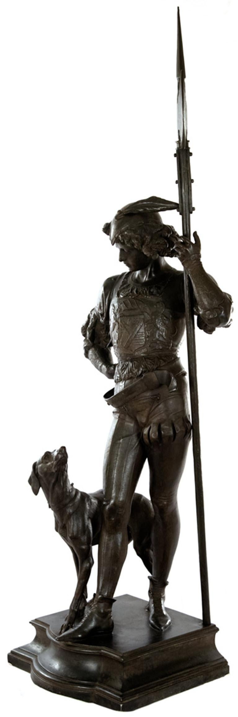 A very fine unmarked and unsigned sculpture of a young guard in Renaissance period costume standing contraposto while holding a spear and standing on a plinth alongside a beautifully modeled dog.

Measures: 58 1/2 x 20 1/2 x 15 in.