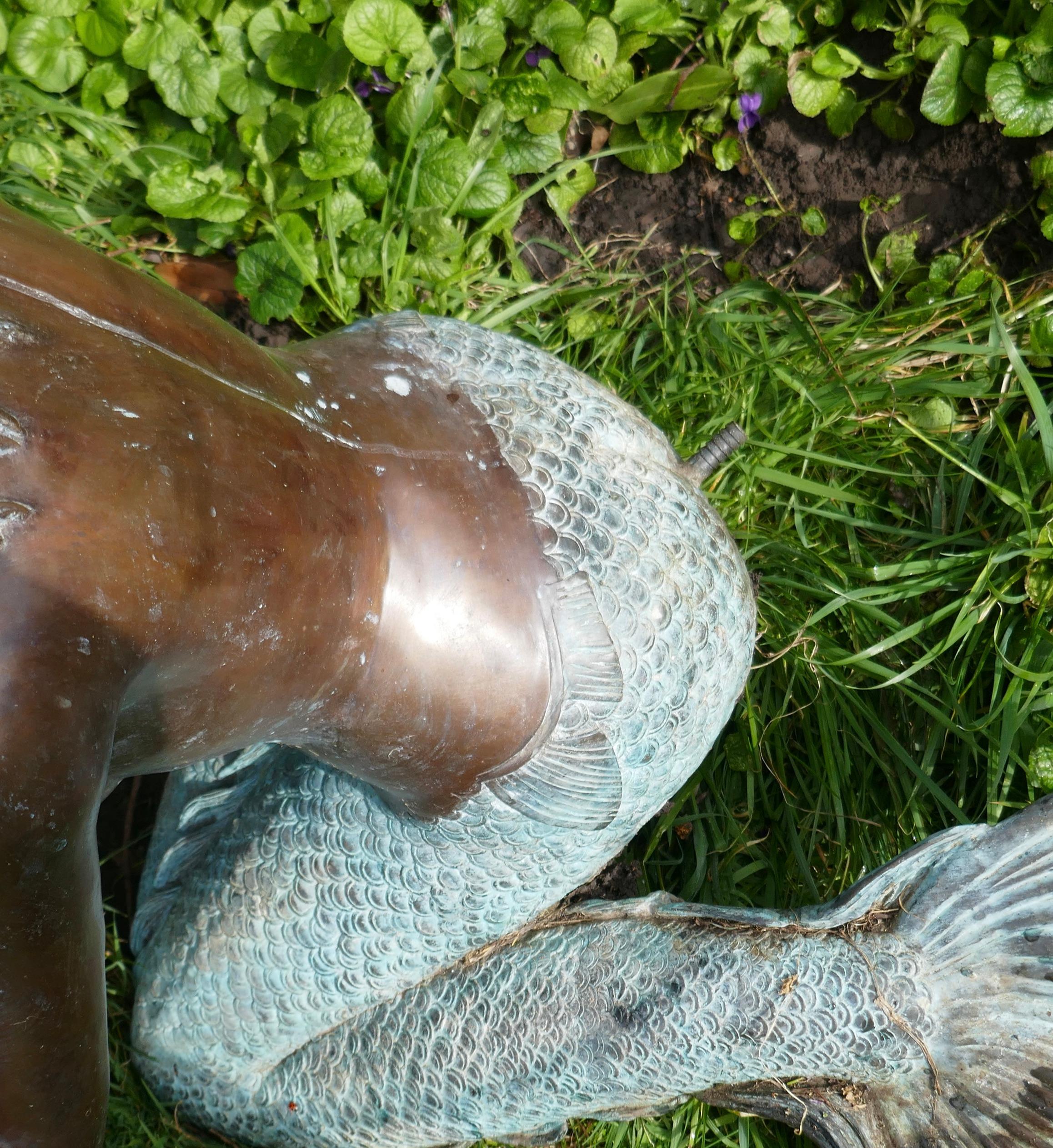 Large bronze kneeling mermaid fountain water feature

A superb large bronze this one is designed is as a fountain
Our beautiful lady is holding a Large Conch Shell, this is where the water falls from (there is a pipe in the base of her back to