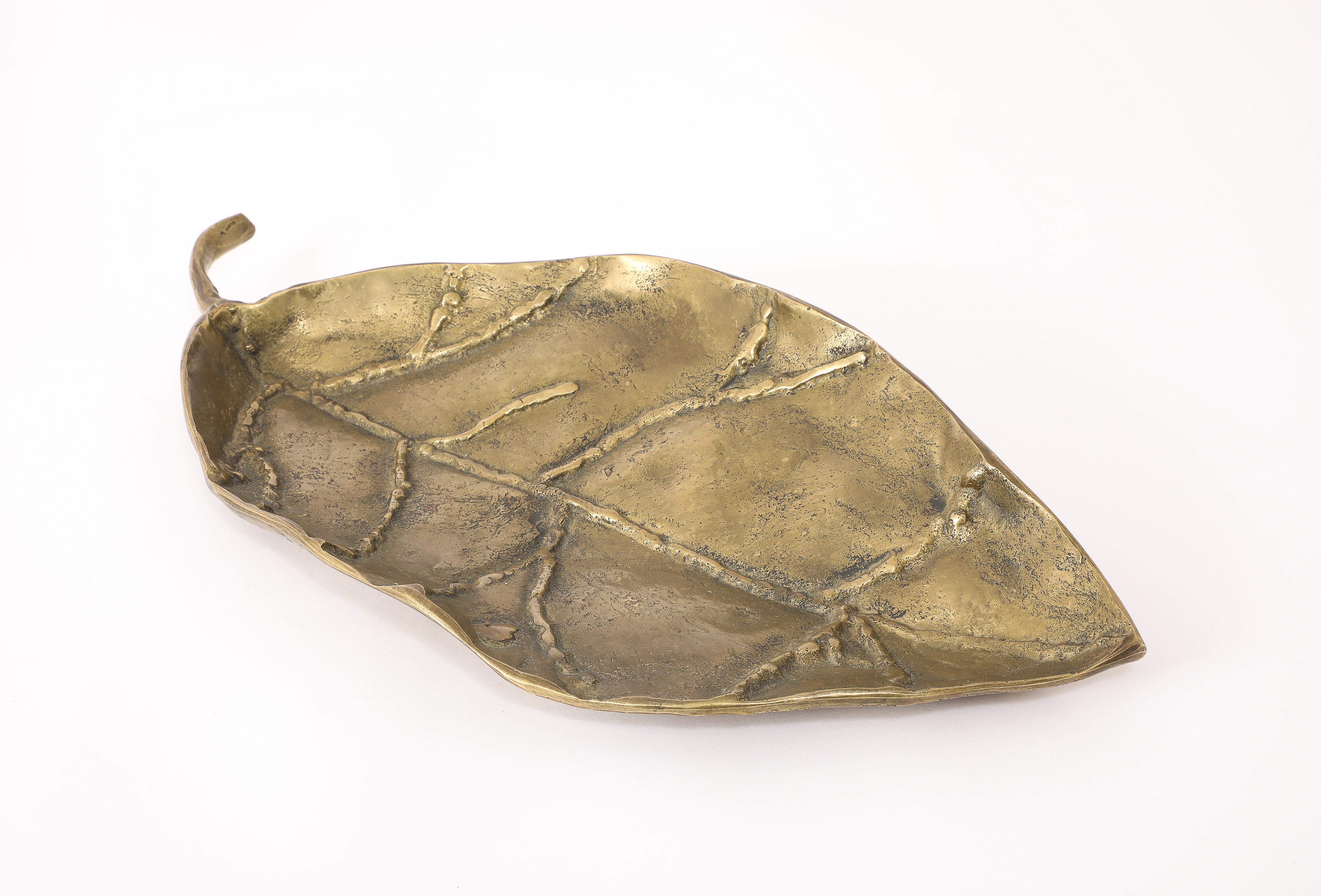 Large and heavy Bronze leaf with a stylized segment made with a bronze weld, a statement piece.