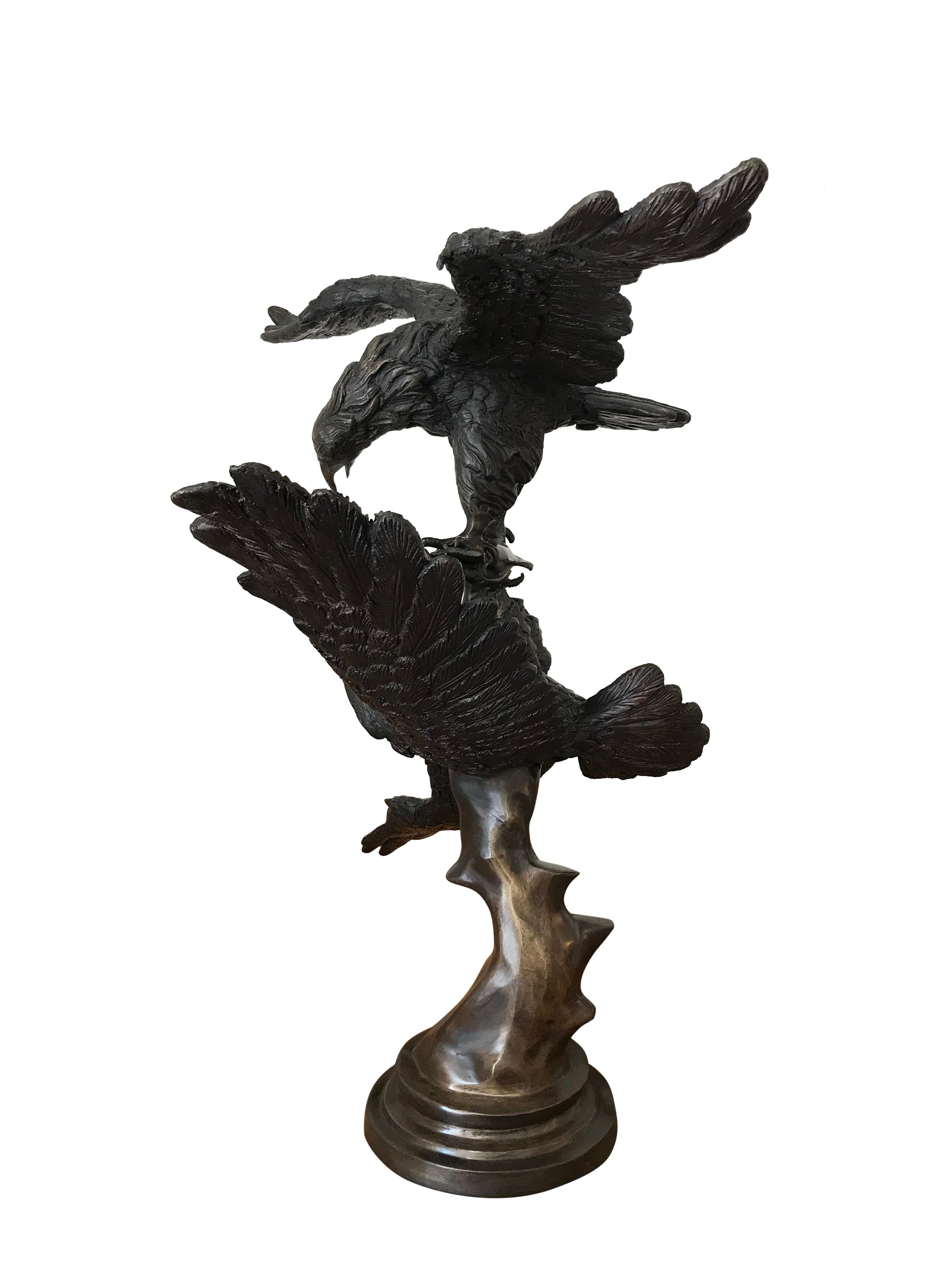 Beautifully detailed large bronze of two eagles fighting over a fish on a solid bronze naturalistic setting, with bronze base. Indistinctly signed K.T. In excellent condition.