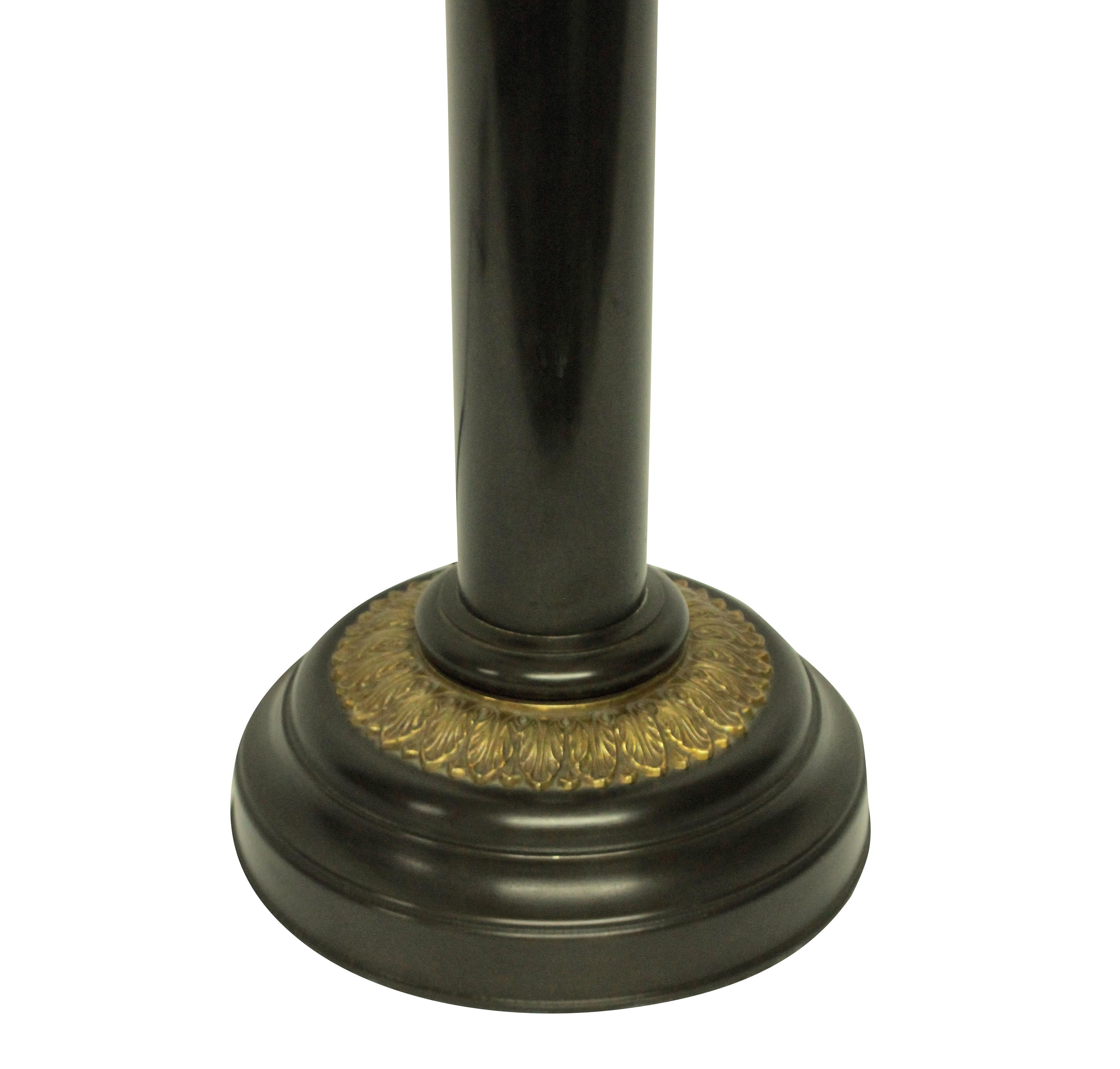 A large English bronze and ormolu column lamp in the Regency manner, made for 10 downing street, where several of these lamps can be found.