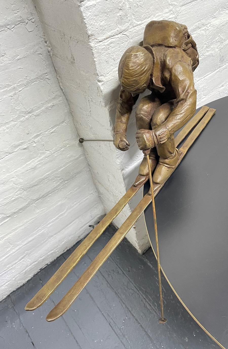 Large decorative bronze sculpture of a skier signed and dated on one of the skis.  This sculpture is not free-standing and will need a base.