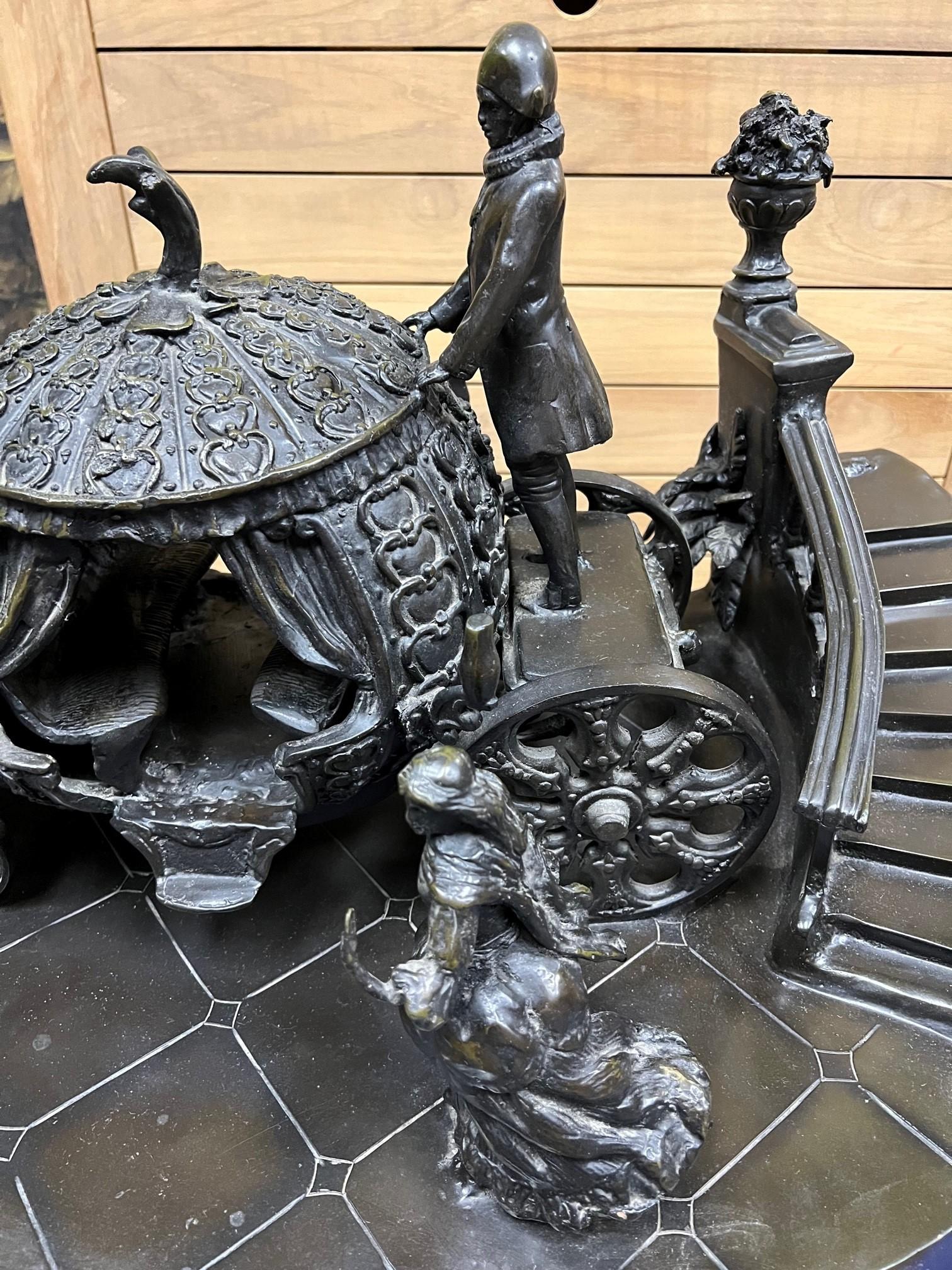 Impressive bronze sculpture of Cinderella's famous midnight run to the pumpkin carriage. Cinderella is running down the staircase losing her glass slipper on her way to the pumpkin carriage before the midnight deadline. This is a great bronze
