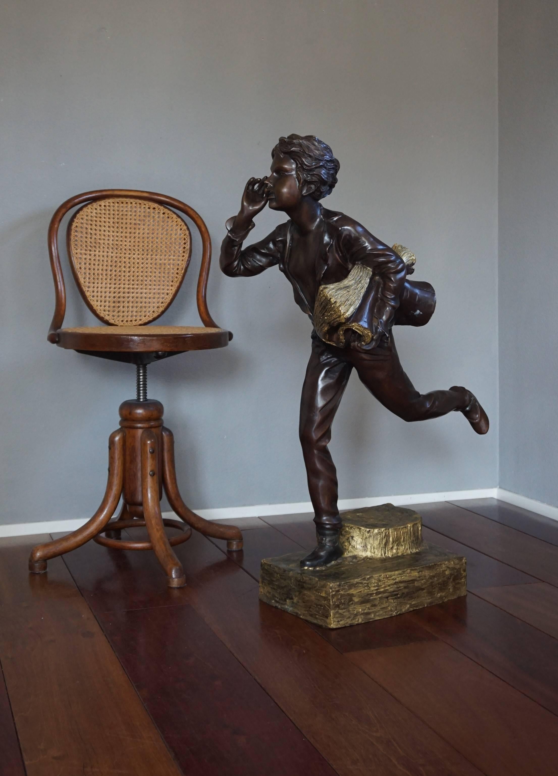 This rare and highly decorative, 1920s style newspaper boy has an amazing patina. In the early 20th century many if not most of the newspapers sold in the streets were offered by boys and young men. This large bronze sculpture of such a boy is both