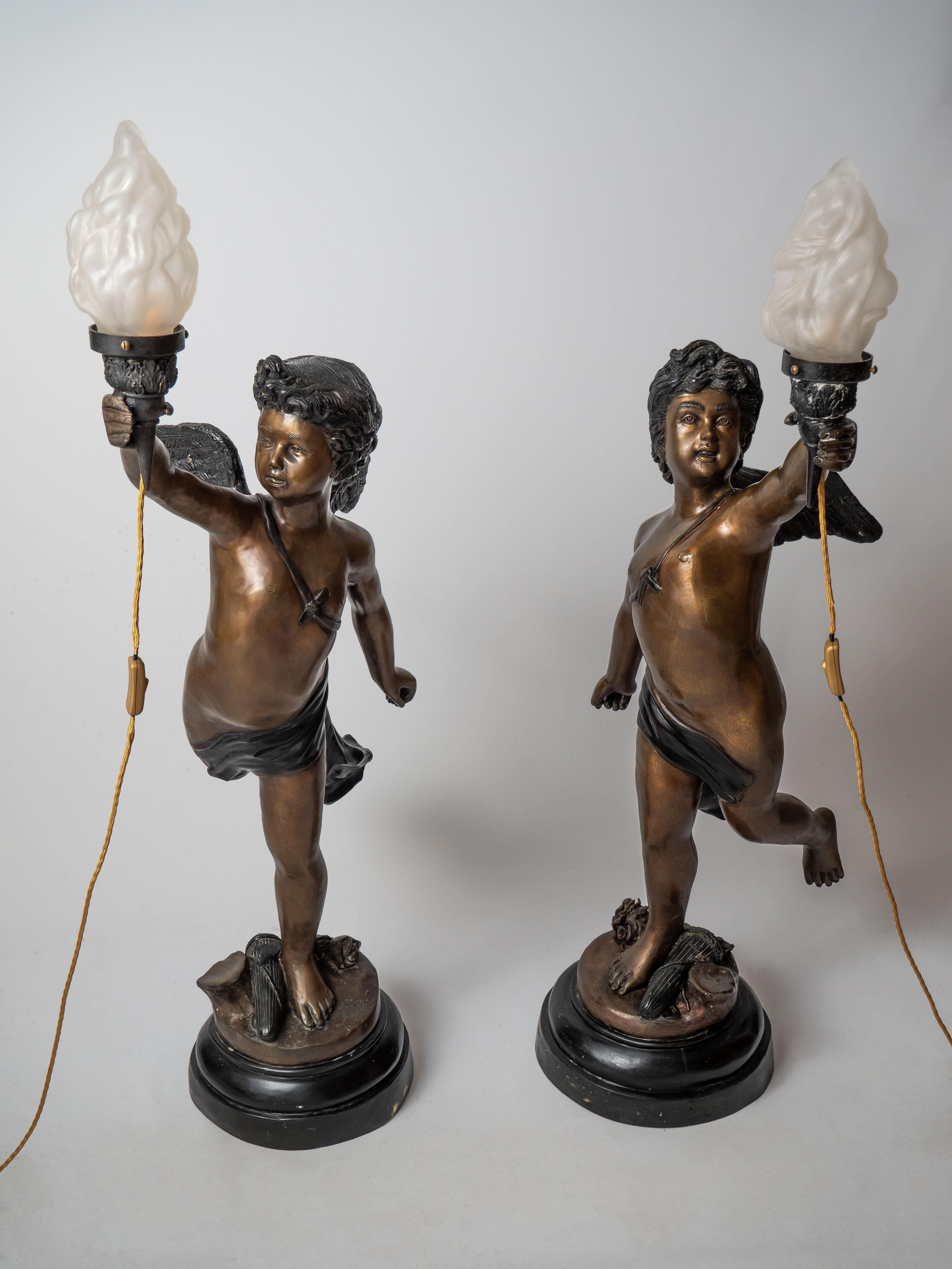 20th Century Large bronze statues of Cupids carrying a torch For Sale