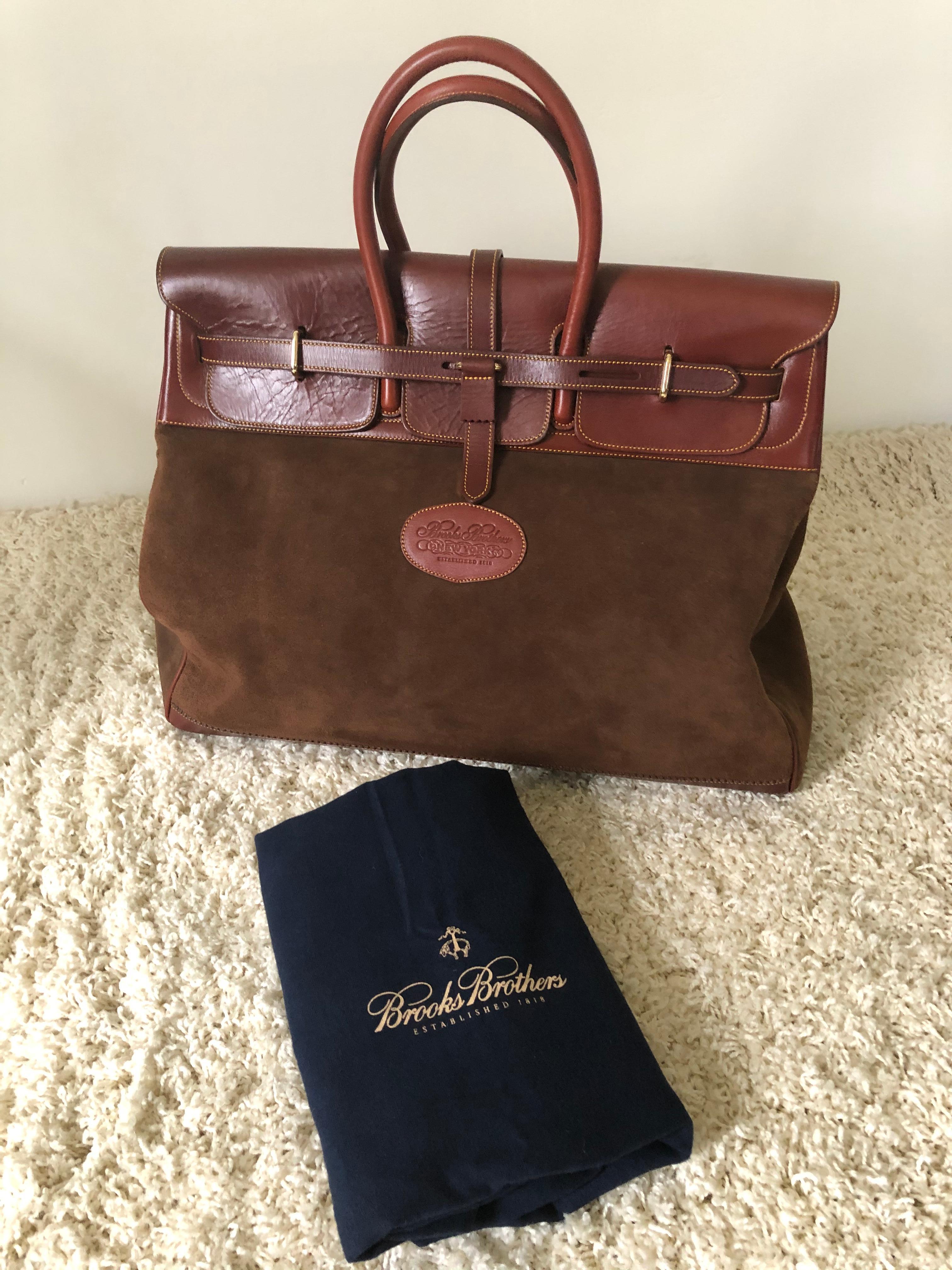 Large brooks brothers leather and suede overnight bag, burgundy leather brown suede, double handle and straps to close and can add lock, also outer felt large cover new old stock very small production.