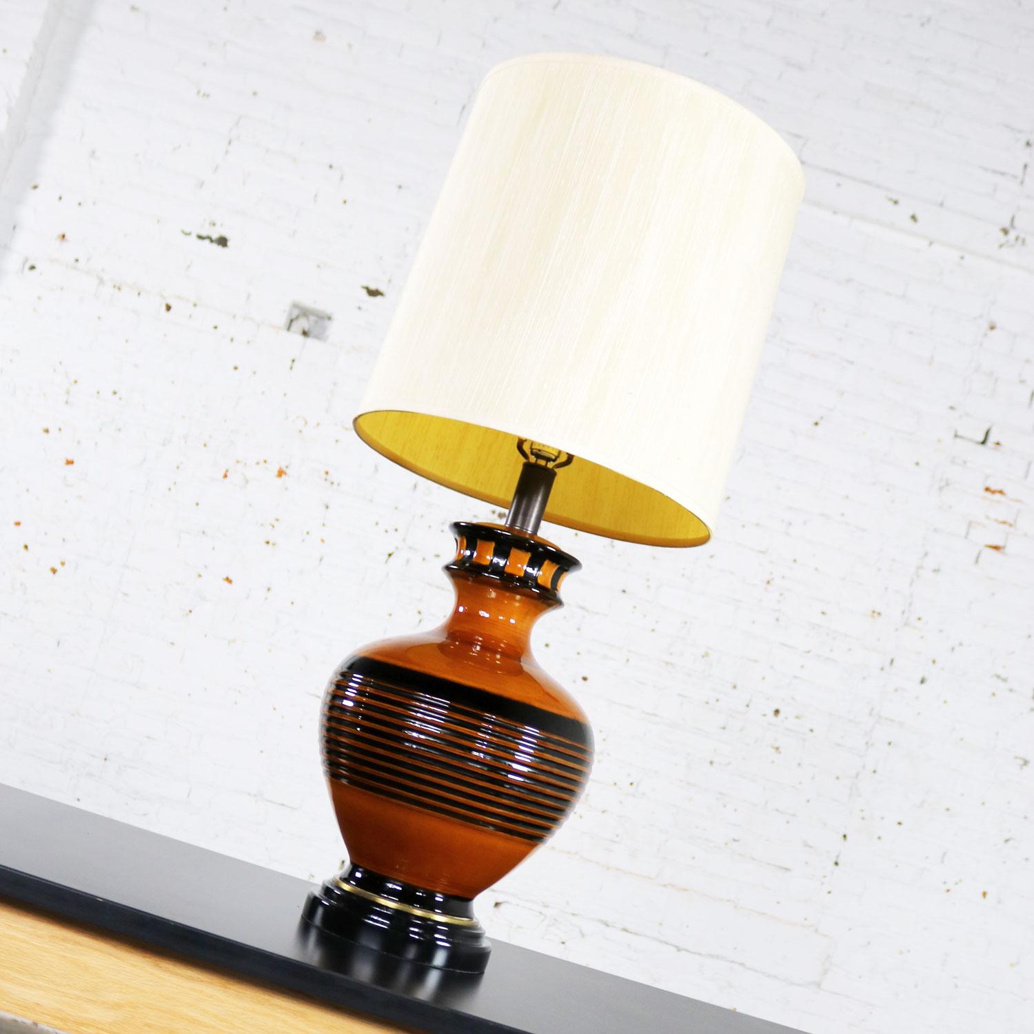 Handsome Mid-Century Modern large brown and black bulbous ceramic lamp. It is in fabulous vintage condition. It wears its original nubby silk-look drum shade which is not without signs of age but still beautiful. The wood base has been restored and