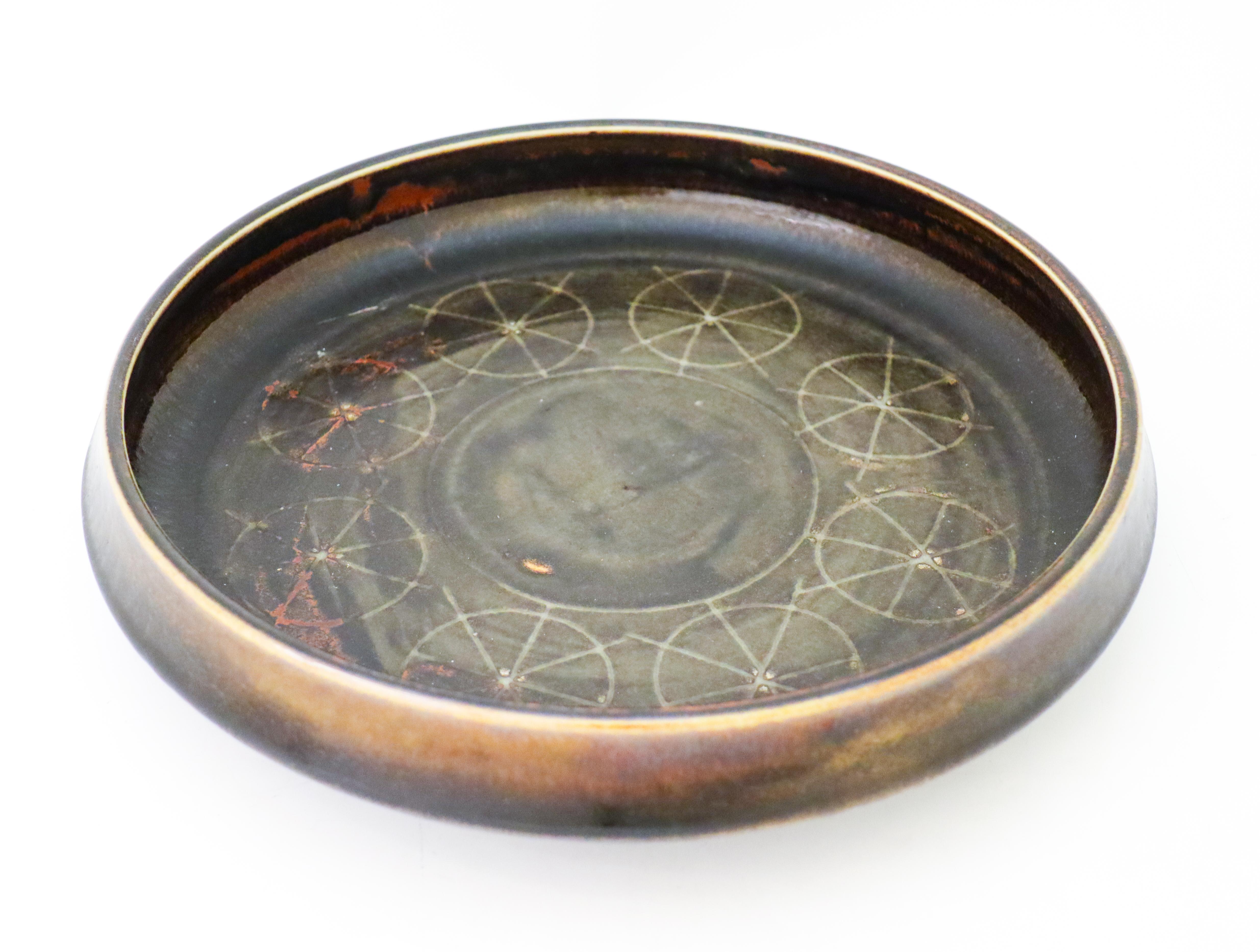 A large brown ceramic bowl designed by Carl-Harry Stålhane at Rörstrand, the bowl is 31 cm (12.4