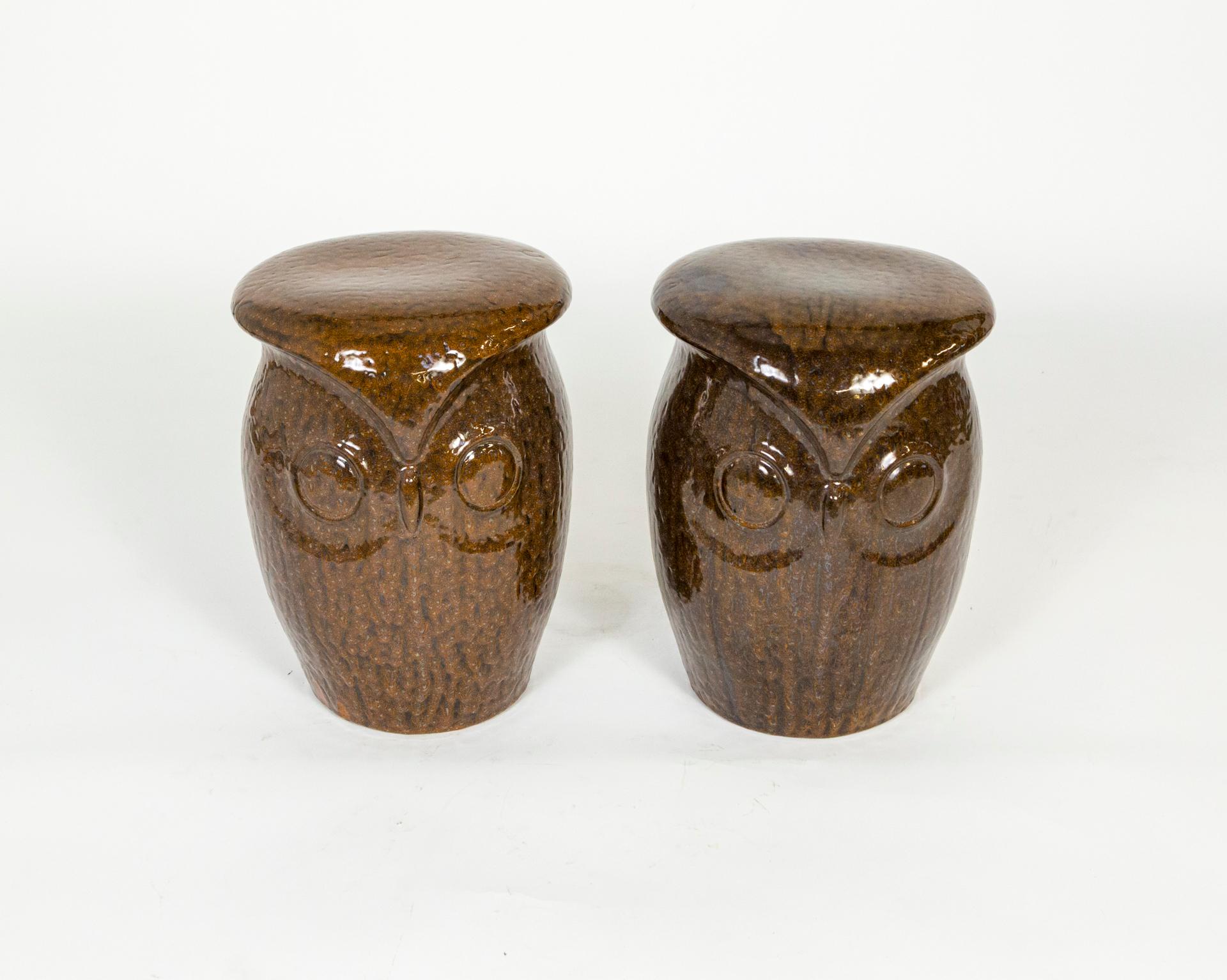 A pair of late 20th century, ceramic, owl garden stools. Each stool has 2 owl faces. Closet inspection of the brown glaze reveals beautifully intricate pattern. Measures: 18” height x 14” diameter.