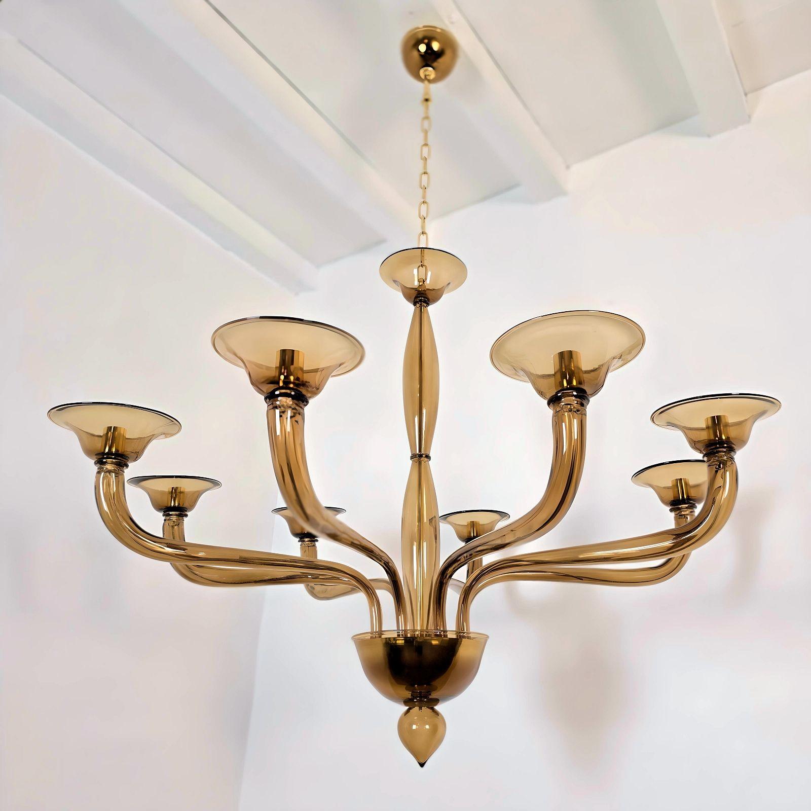 Mid-Century Modern brown Murano glass chandelier, attributed to Seguso, Italy 1980s
The large chandelier is made of transparent brown handmade Murano glass with gold plated mounts.
The Murano chandelier has 8 arms - lights.
It's rewired for the US