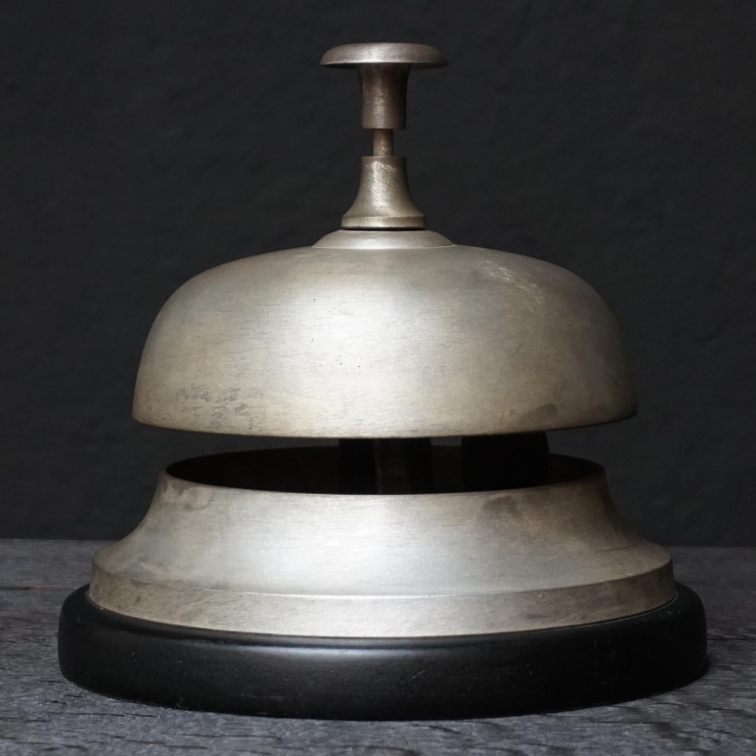Old huge vintage brass lobby front desk bell from a hotel in Amsterdam on a wooden base.

Very special in its size; 9