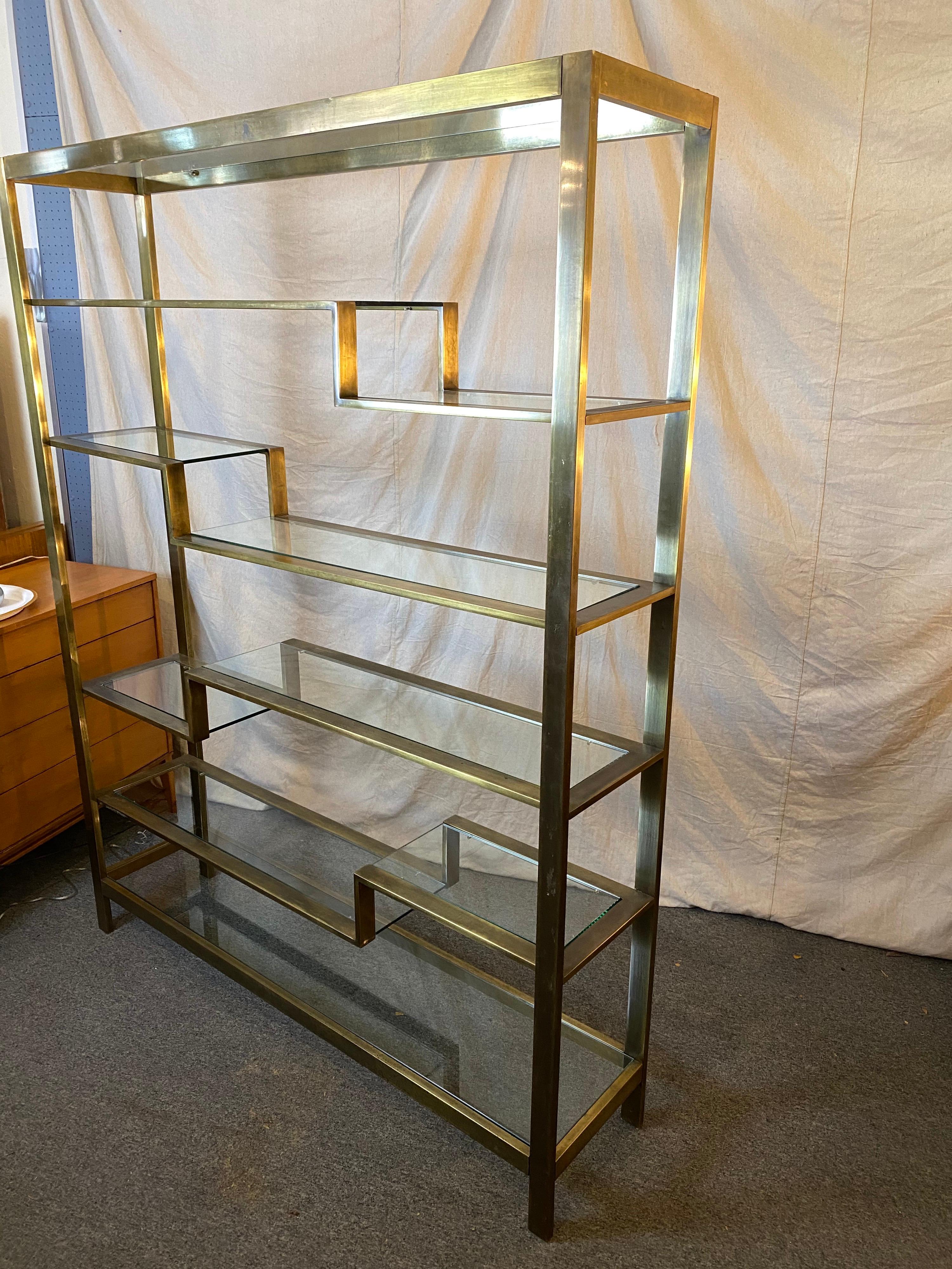 Large brushed brass étagère made up of a rectangular stock, great size and scale! 6 levels with glass shelves, one full glass shelf top and bottom, and then the other 4 levels with a step down. Each level two pieces of glass. Brushed brass finish is