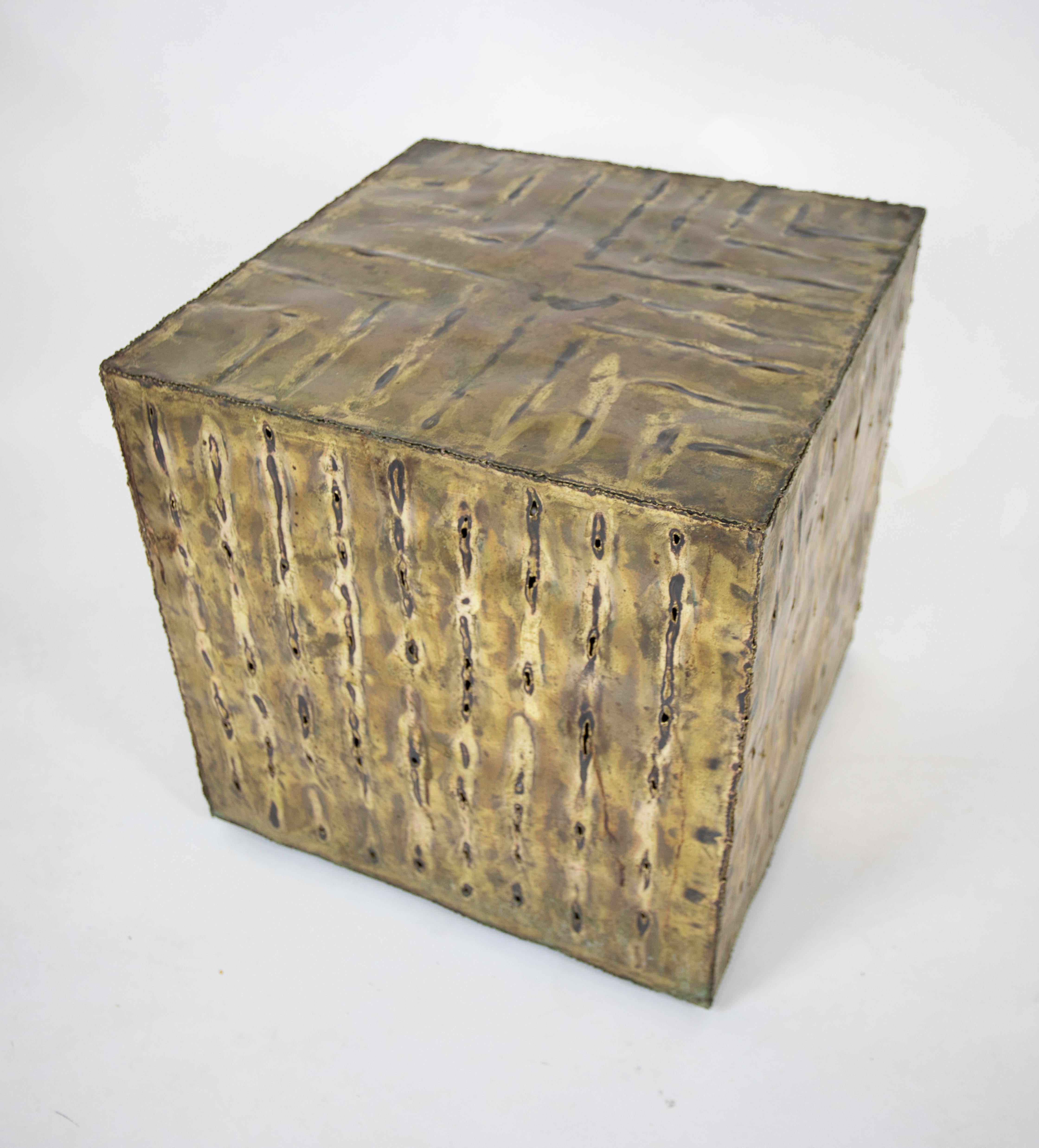 Patinated and torch-welded brass cube table.