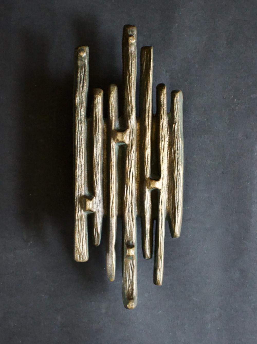 A large bronze door handle in abstract brutalist design. Mid-20th century, European.

This is a heavy piece, made of patinated cast bronze, with varying tones - dark brown, green, gold - from age and use. The handle can be used on exterior or
