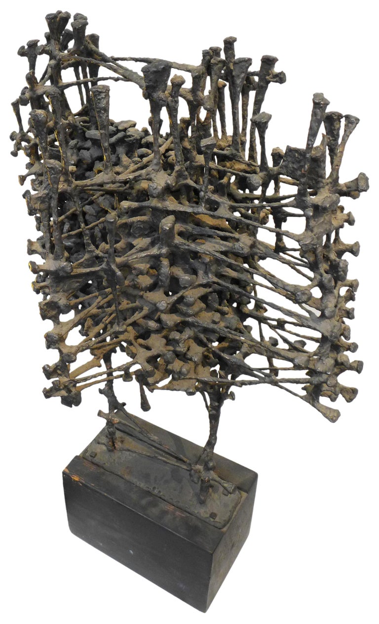 A fantastic 1960s cast iron brutalist sculpture by John Cook, professor at Penn State School of Visual Arts. A wonderful abstract expressionist statement; an upright jutting cluster structure with an alluring mix of texture and openwork. Mounted on