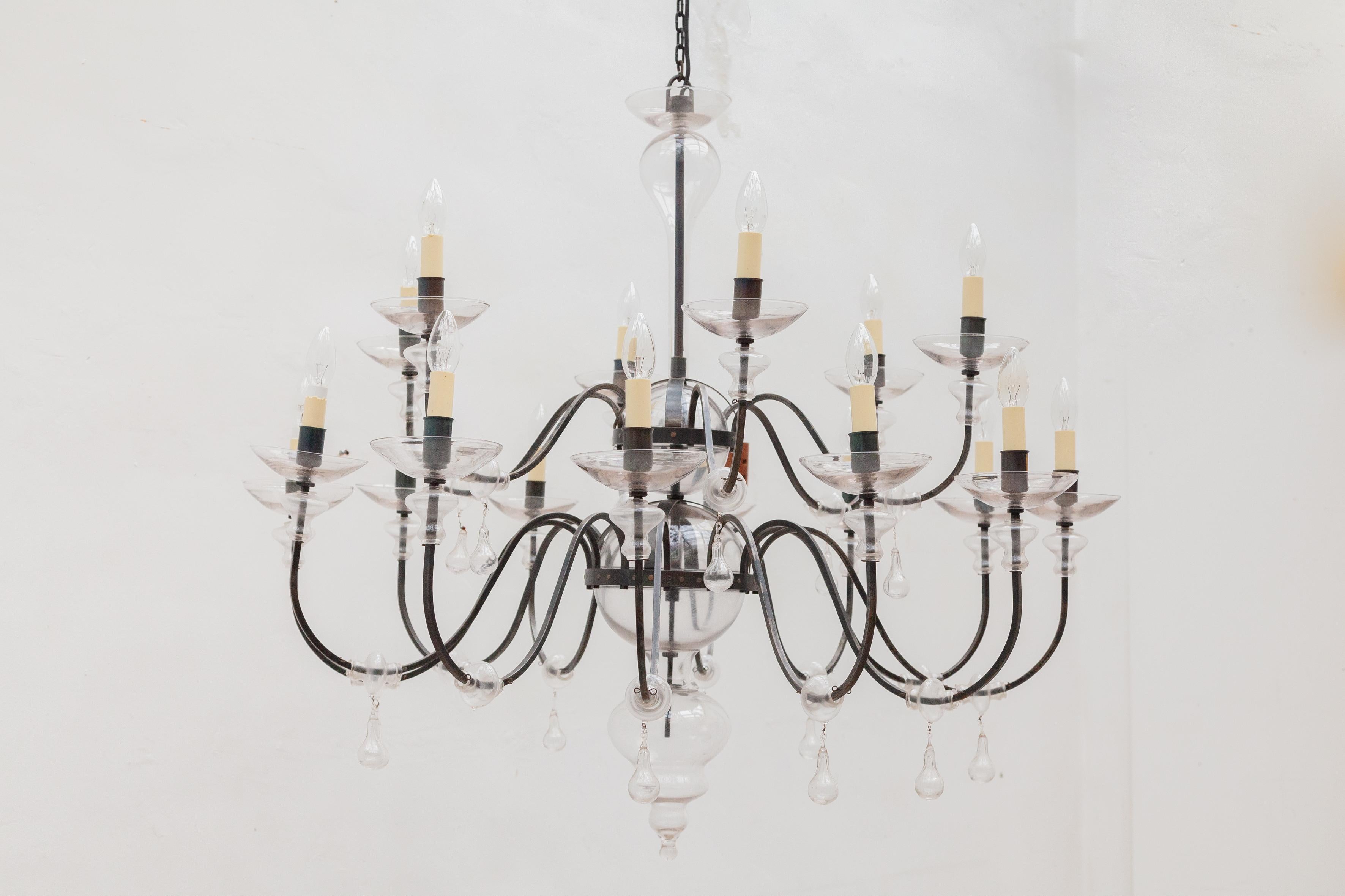 A beautiful classic chandelier wit mouth blown glass parts and wrought iron frame stamped by the artist Gunther Lambert circa 1980s is in very good vintage condition.