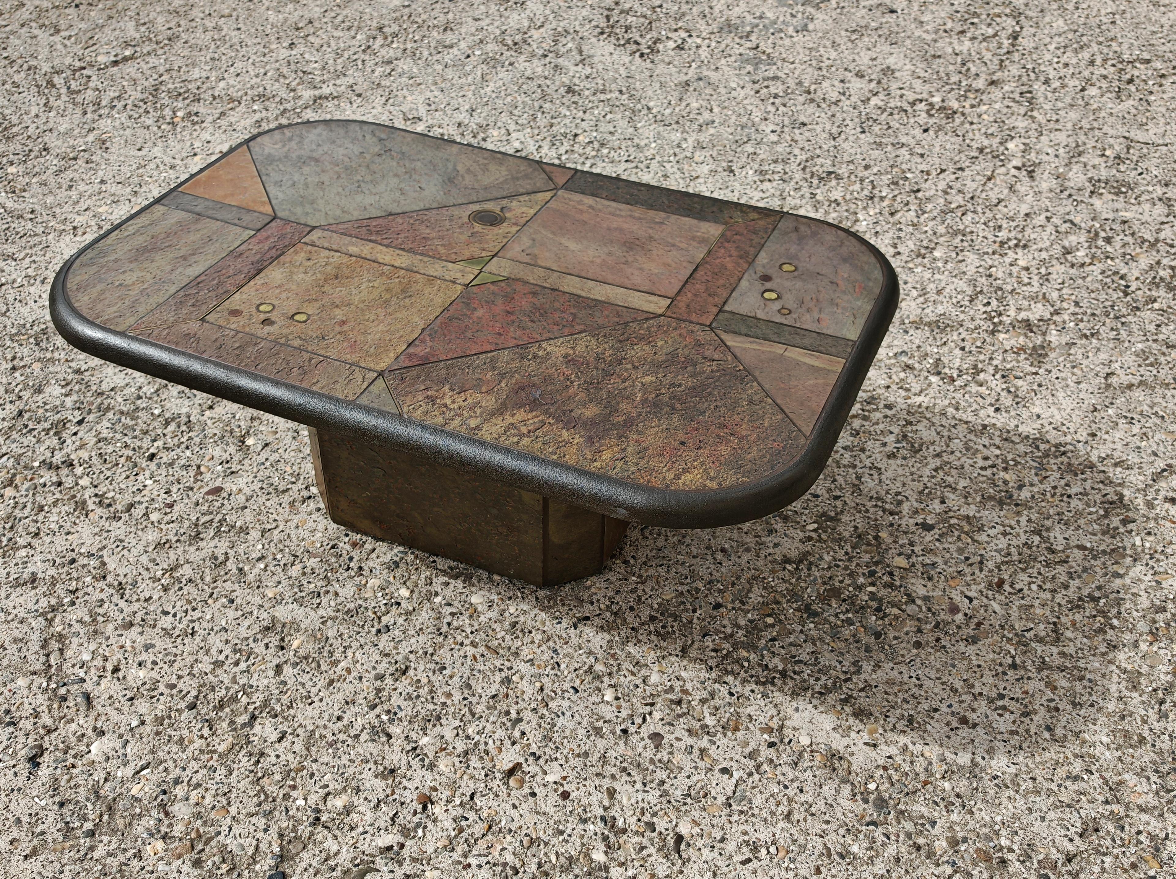 In this listing you wilk find a stunning Brutalist table designed by Paul Kingma. The table is done in various kinds of stone, with brass accent and coins inserted in the stone, one of the Kingma's signature details present on all of the tables he