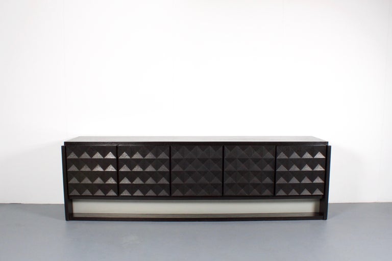 High quality Brutalist sideboard in very good condition.

The sideboard has 5 door panels that show a beautiful diamond shaped graphic pattern.

Behind one door you can find two drawers, behind the other doors you can find one shelve each. 

The