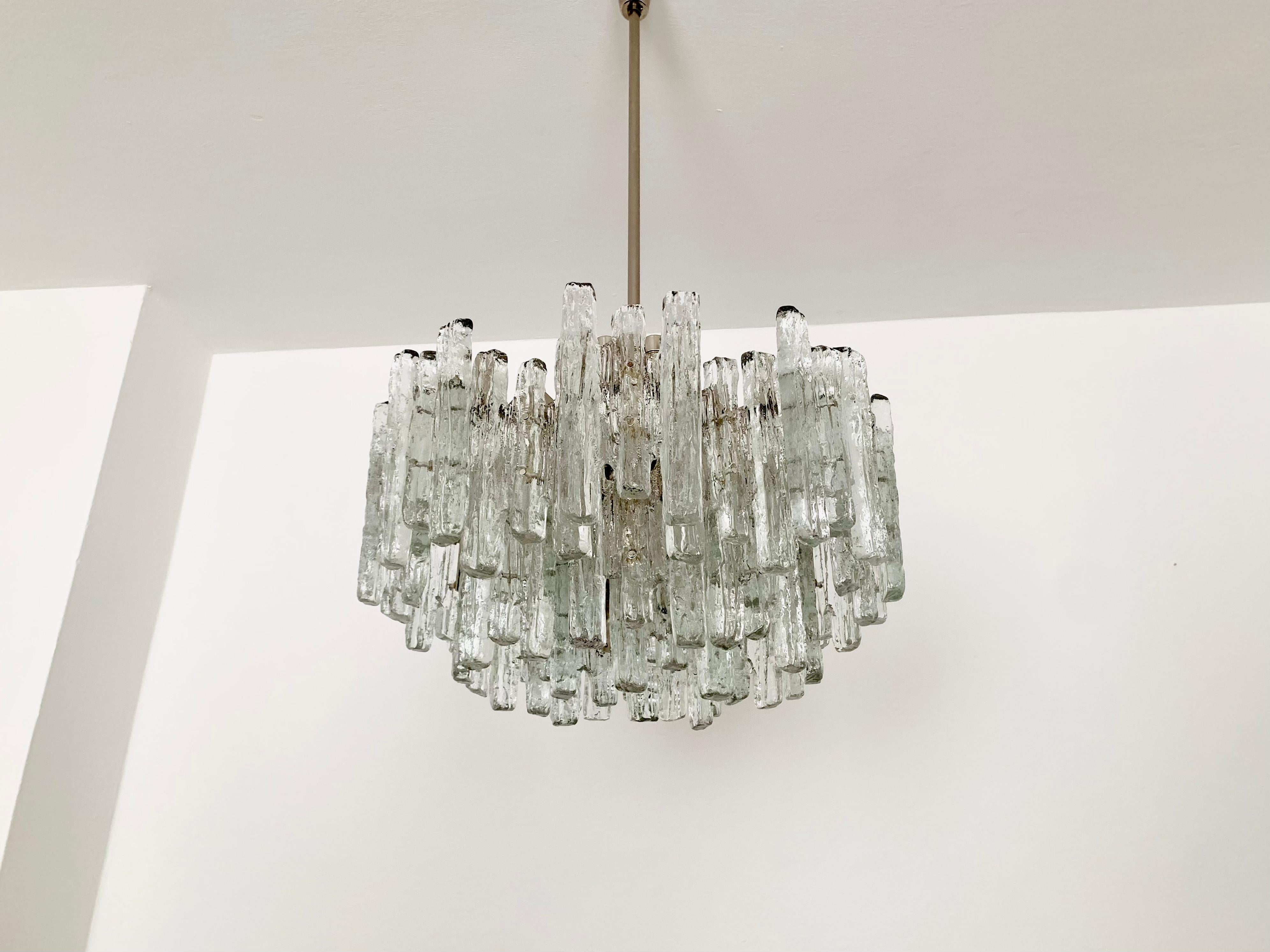 Impressively large and very heavy ice glass chandelier from the 1960s.
The beautifully formed Murano glass elements create an impressive, sparkling play of light.
Exceptionally high-quality workmanship.
Very noble and luxurious appearance and a real