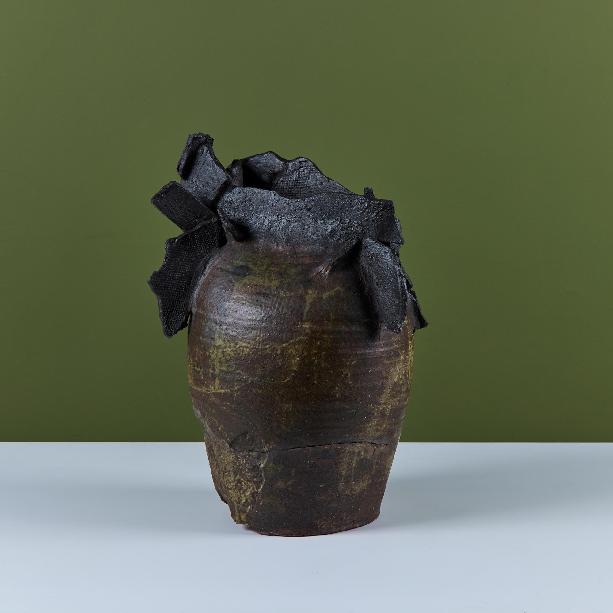Ceramic glazed vase by Japanese American artist, Takao Tomono. The vase features a wheel thrown form with a hand built mouth and 'wing' detailing around the top of the piece. Tomono was born in 1935 and created many of his pieces through the