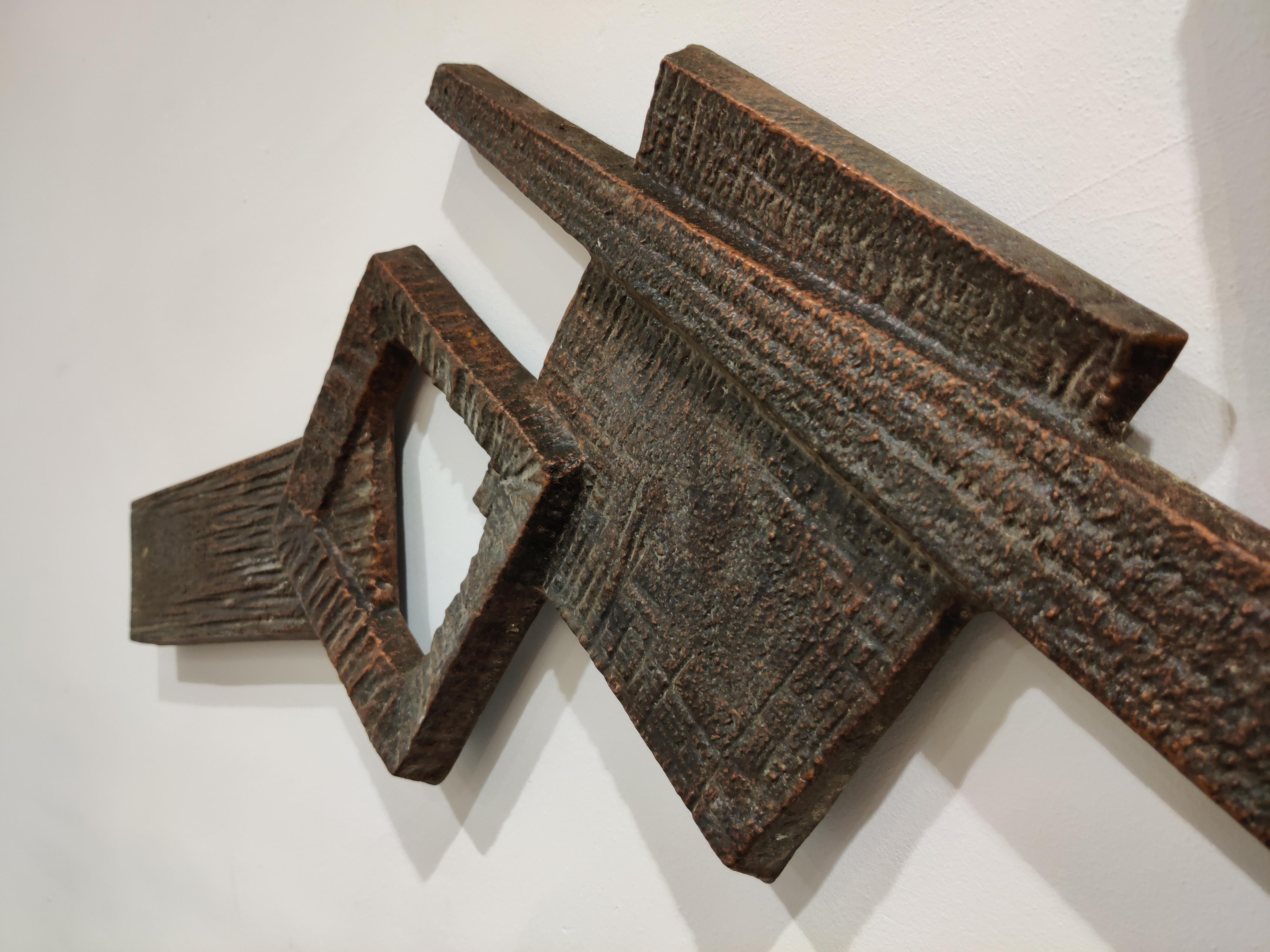Architectural Brutalist wall mounted sculpture made from bronzed cast metal.

This typical 1970s Brutalist design sculpture is a great wall decor and served as a sculpture mounted on a door. It still has the holes for a door handle.

Rare due to