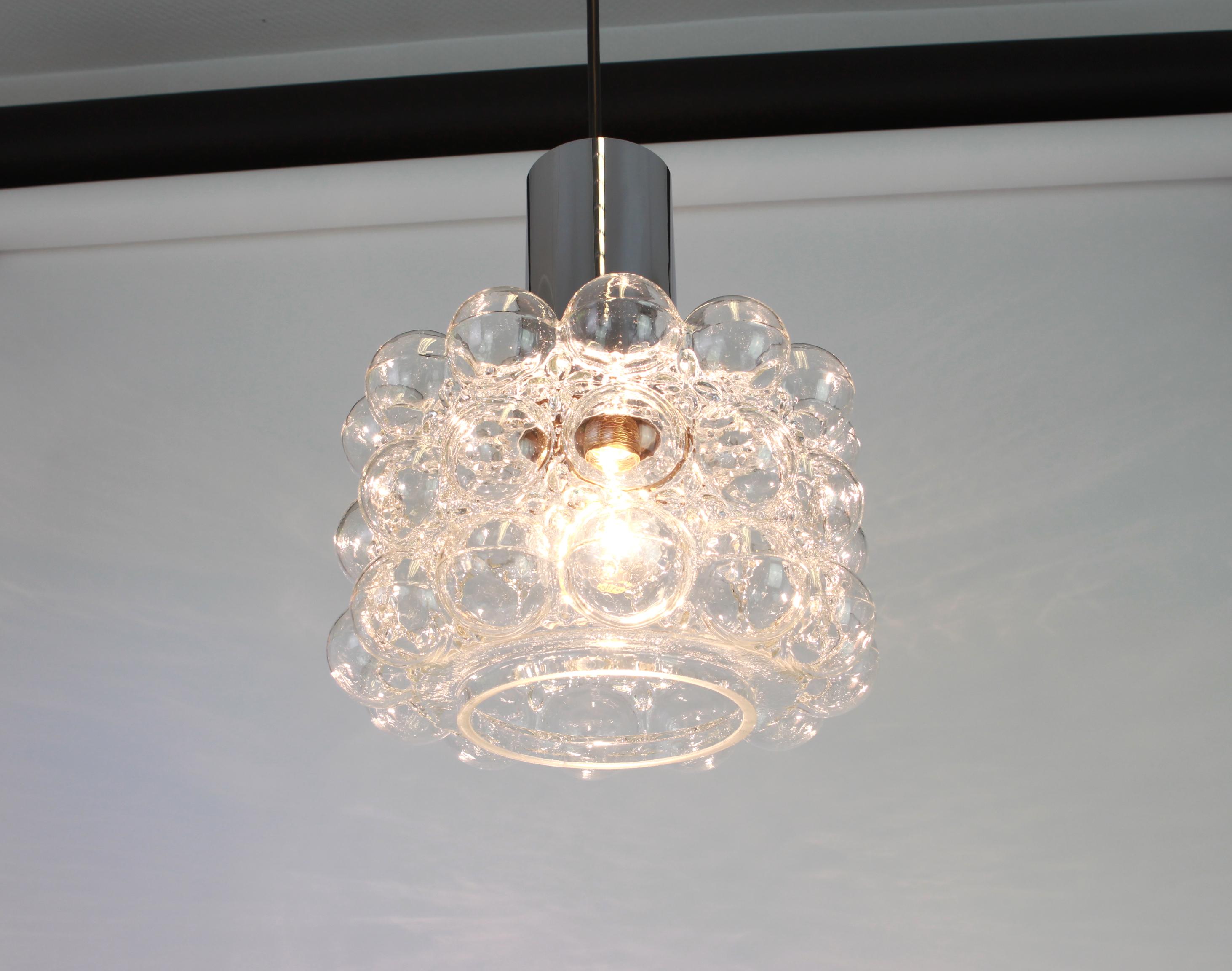 A large round bubble glass pendant designed by Helena Tynell for Limburg, manufactured in Germany, circa 1970s.

Sockets: needs 1 x E27 standard bulb with 100W max each and compatible with the US/UK/ etc standards
Good condition- small tiny hit