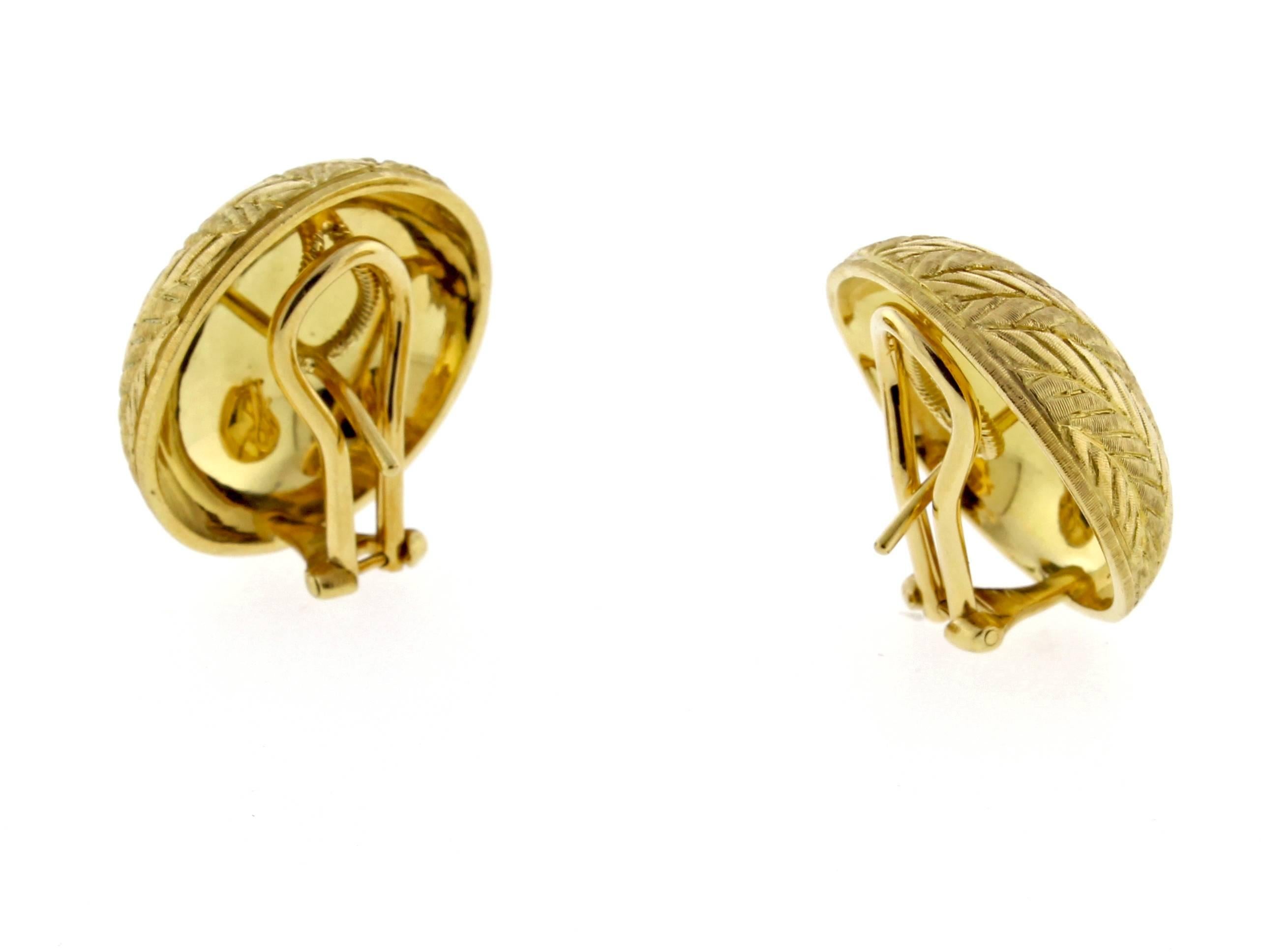 A pair of 18 karat yellow gold brushed finished button earrings with distinctive hand engraved herringbone pattern. Meticulously crafted by iconic Italian jeweler Buccellati, these earring are in as new condition.  Measuring 21.5mm (7/8 of an inch)