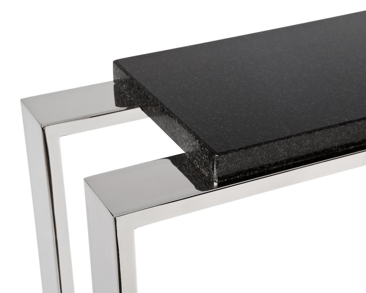 Solid and tube steel base cocktail table with a natural stone, solid surface, wood, lacquer or leather tabletop. 

Shown with natural stone top and a polished nickel or antique brass base.

Metal finishes available in a plated steel or a powder
