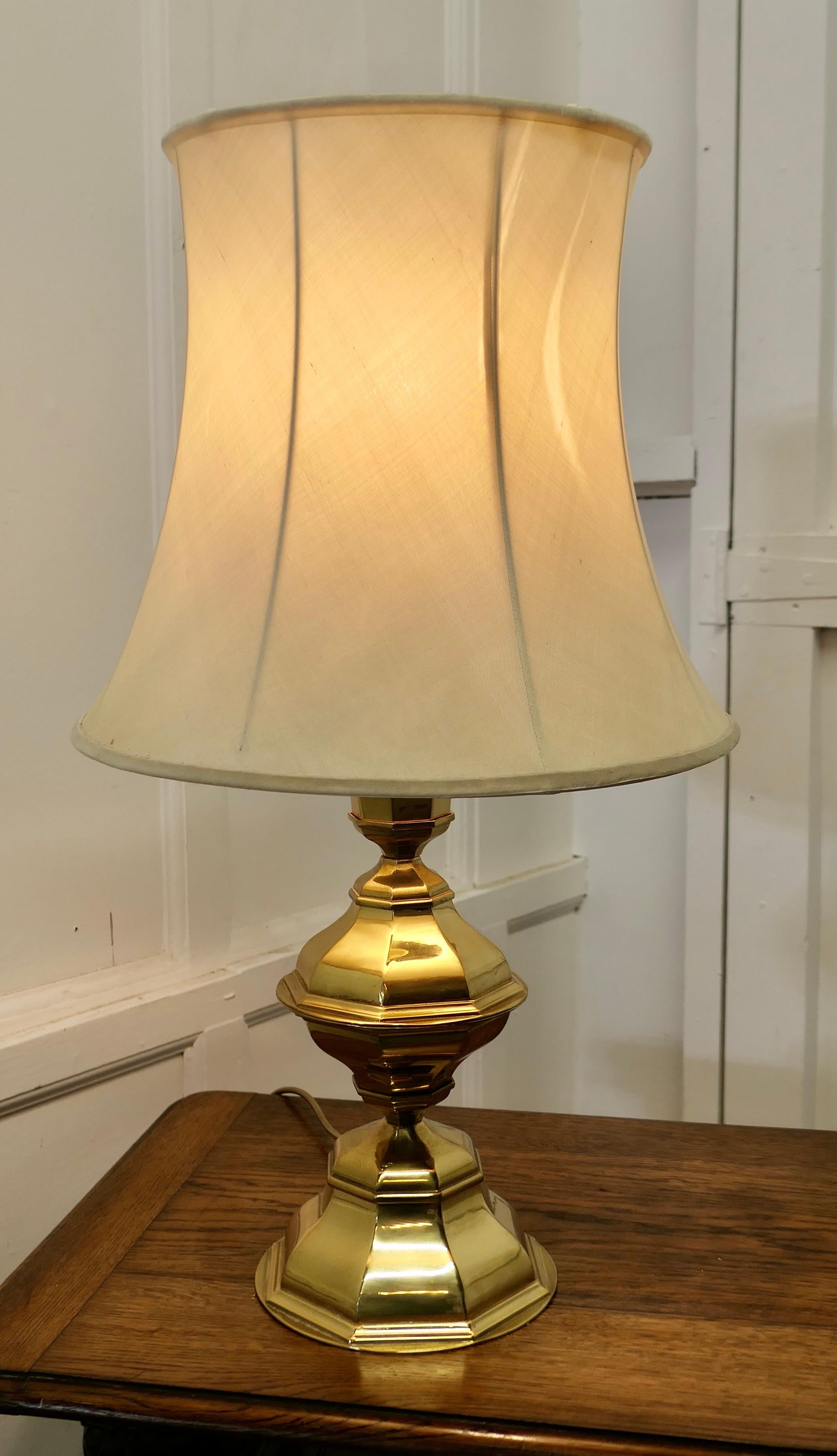 Large Bulbous octagonal brass table lamp 

This is an unusual Lamp it has a large brass 8 sided stepped base I have shown the lamp with it’s lampshade but this is somewhat worn now 
The lamp is fully wired and in good condition, a statement piece