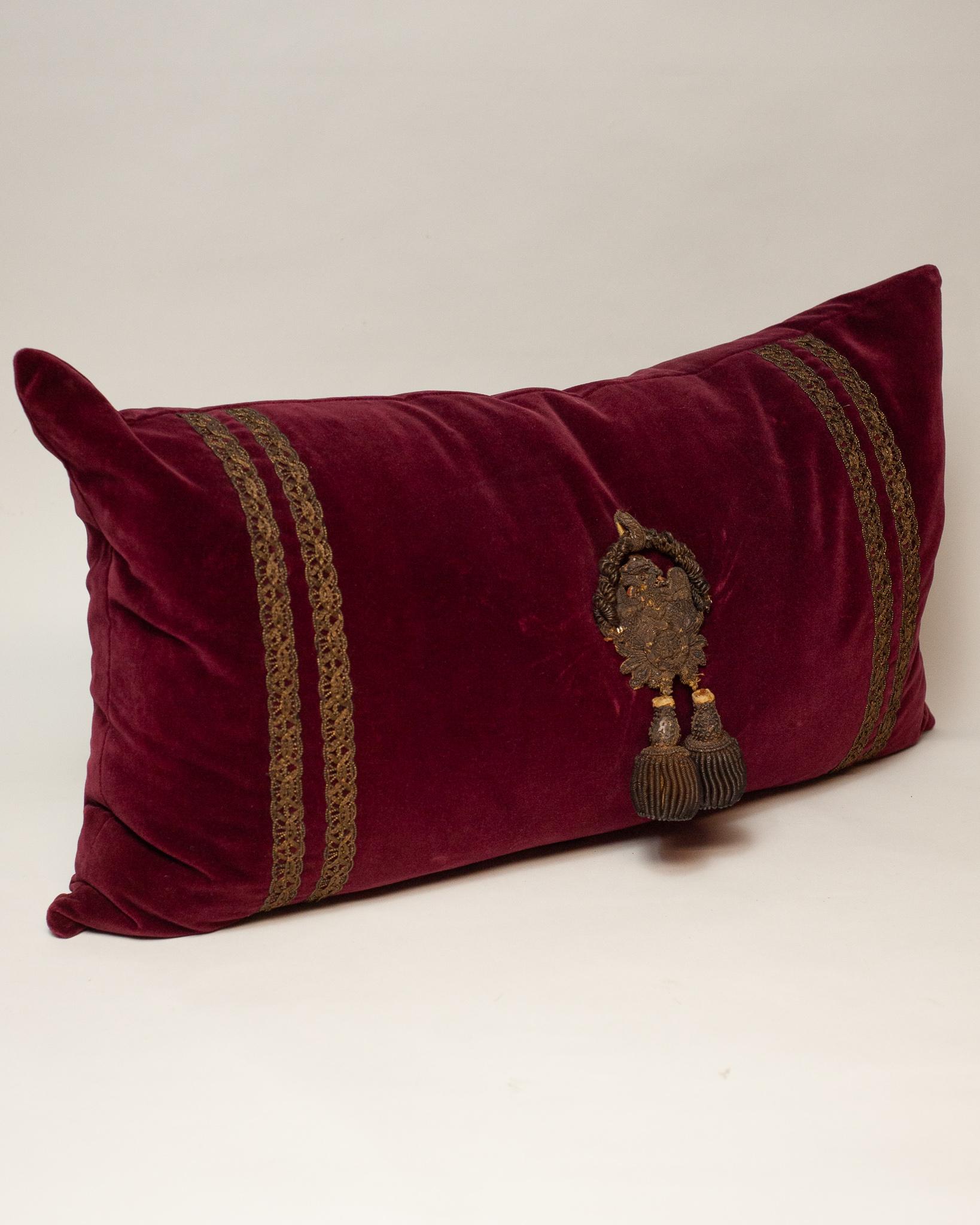 red pillow with gold tassels