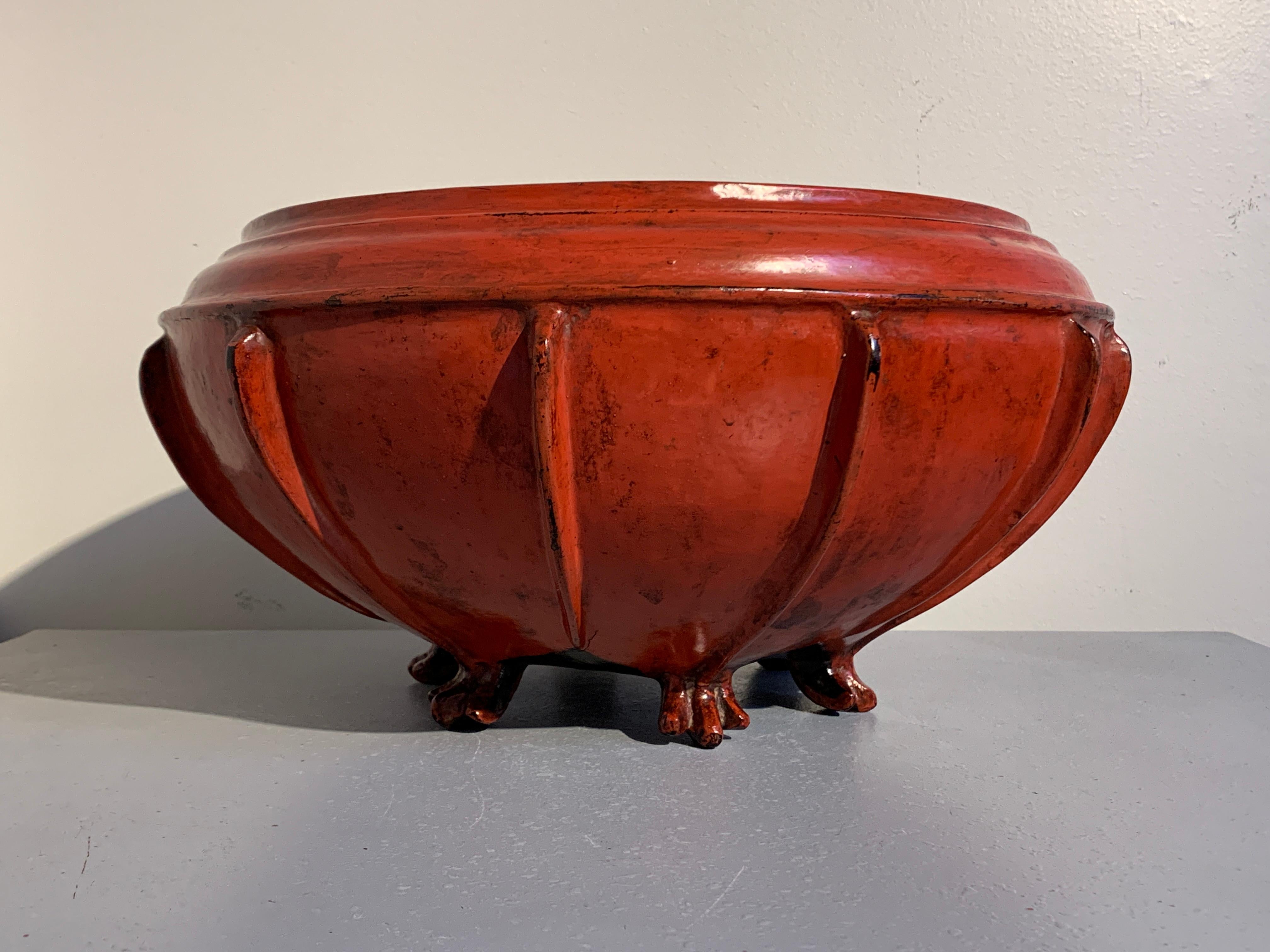 A stunning Burmese woven bamboo and red lacquered large offering bowl, late 19th or early 20th century.

The attractive footed bowl of large melon or squash form, with a slight neck and wide mouth, and an even wider body featuring twelve ribs, all