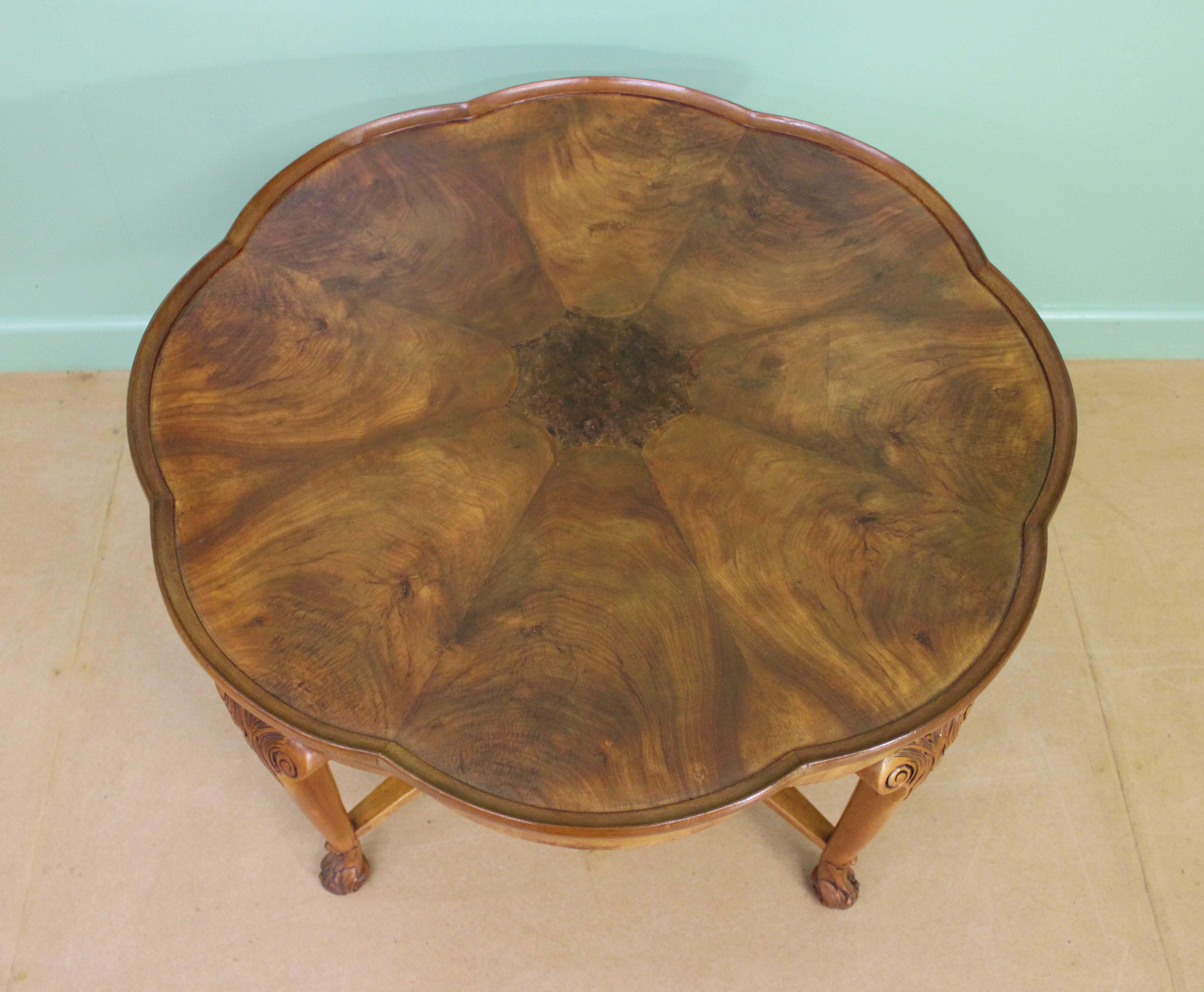 A shaped top Queen Anne style burr walnut coffee table of generous proportions. Of very good construction in solid walnut with attractive burr walnut veneers. The shaped top is fitted with segmented veneers and a central inset panel, all surrounded