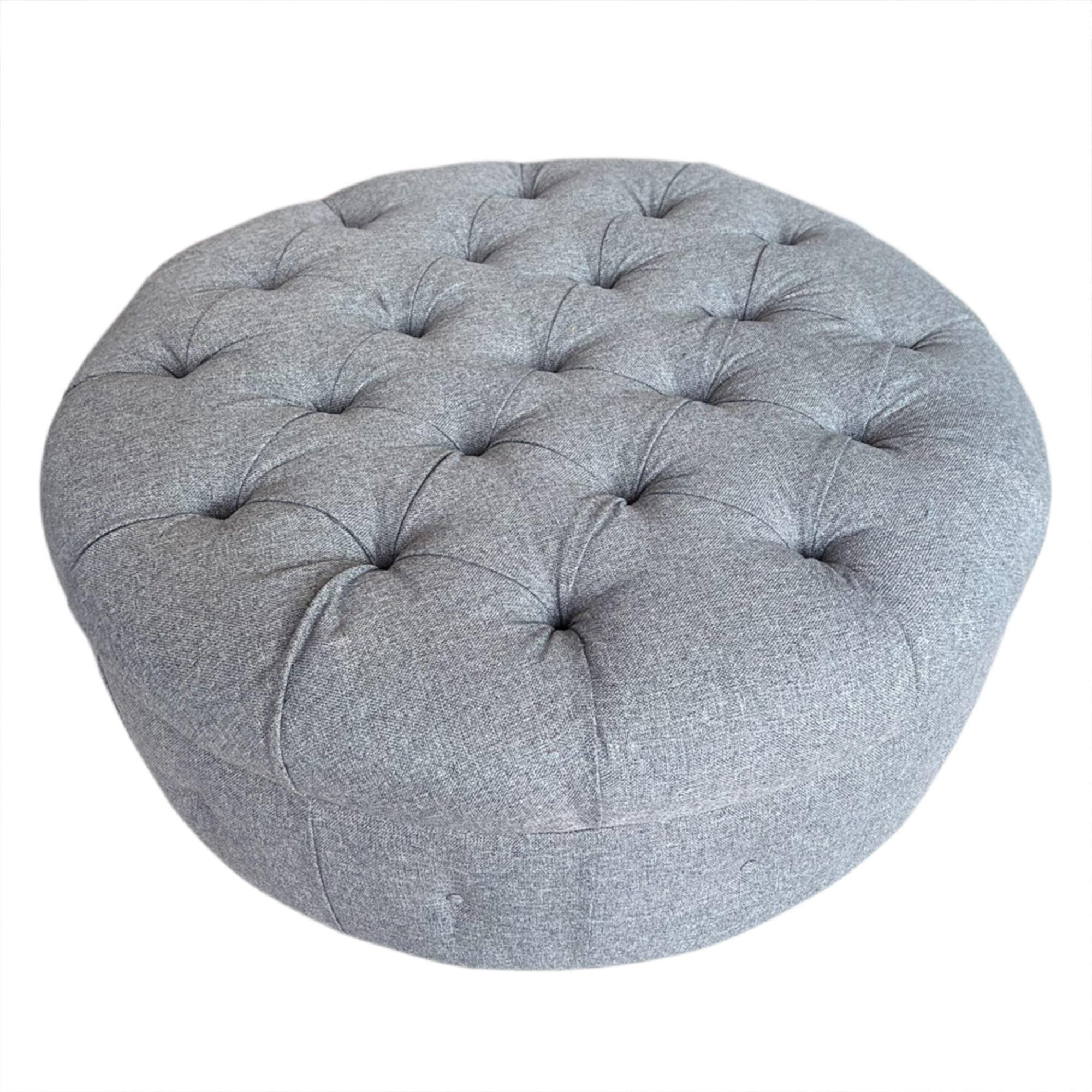 The original owner of this large buttoned pouffe had it specially made to their own design. We've had it reupholstered in luxurious wool fabric and it sits on ebonised, round tapering feet. 

Made in Britain in the late 20th century. 

A great